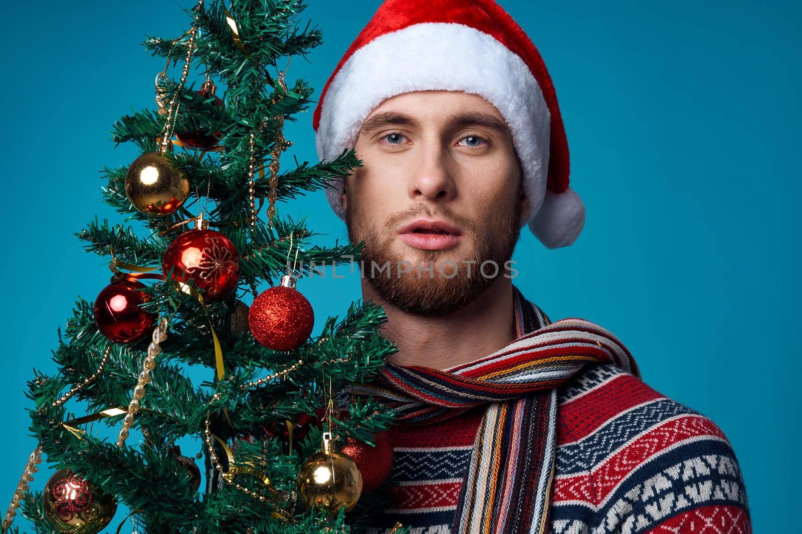 handsome man with a tree in his hands ornaments holiday fun isolated background. High quality photo