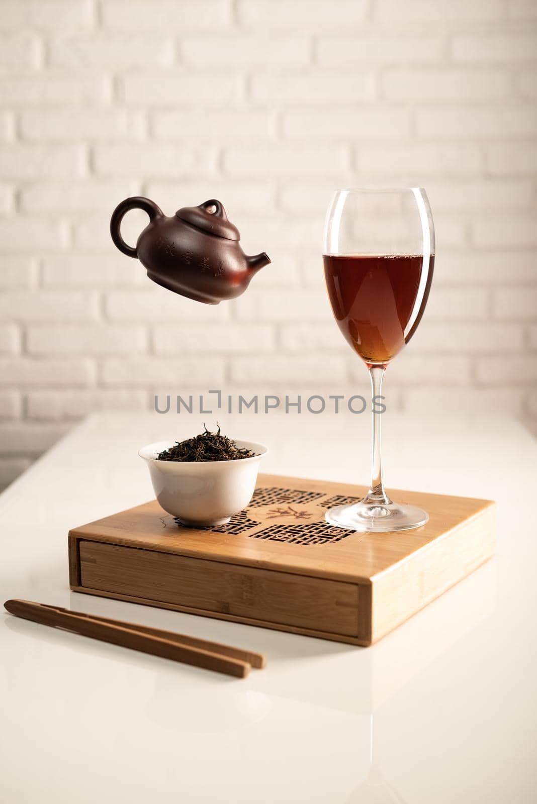 table with appliances and a wine glass in which tea is brewed