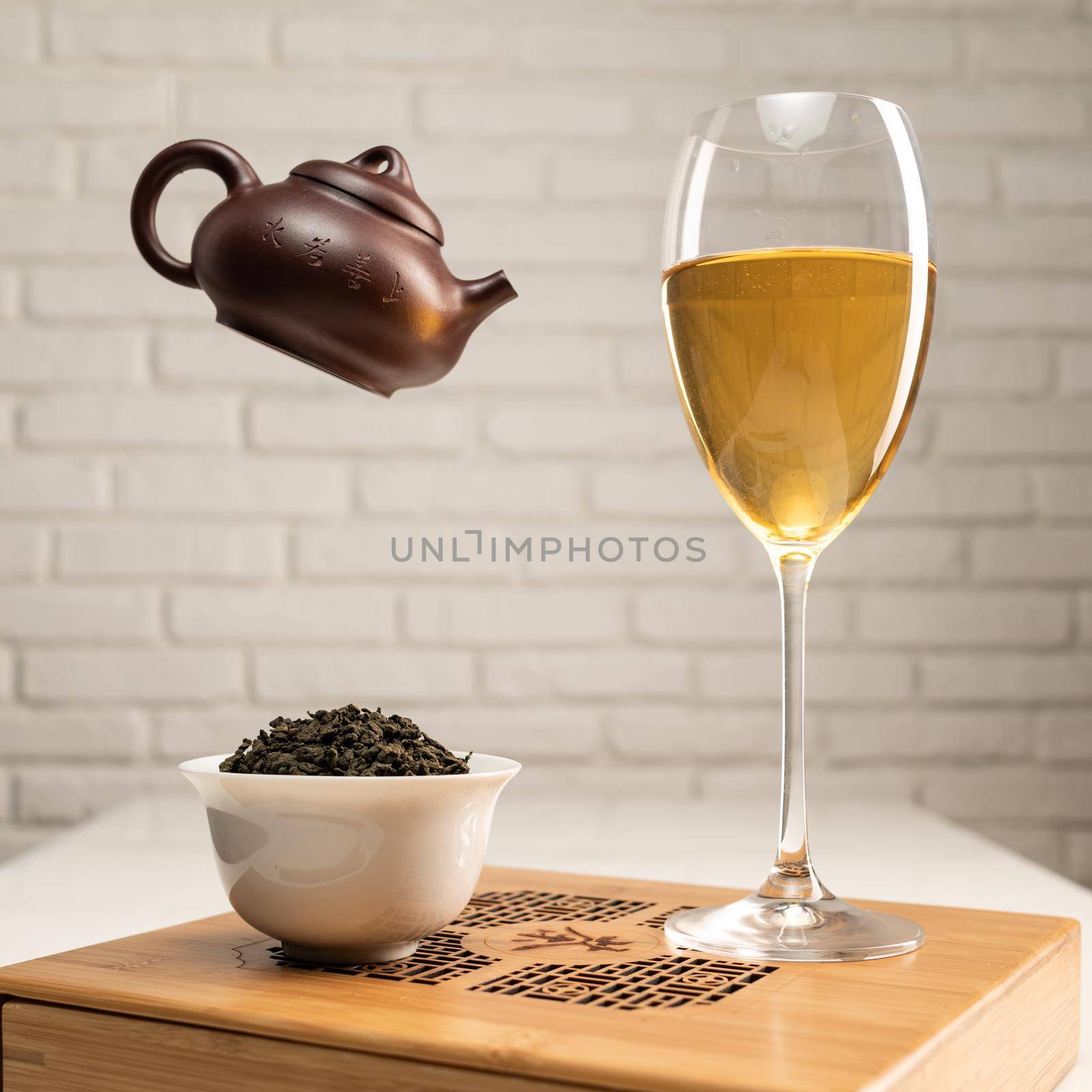 table with appliances and a wine glass in which tea is brewed