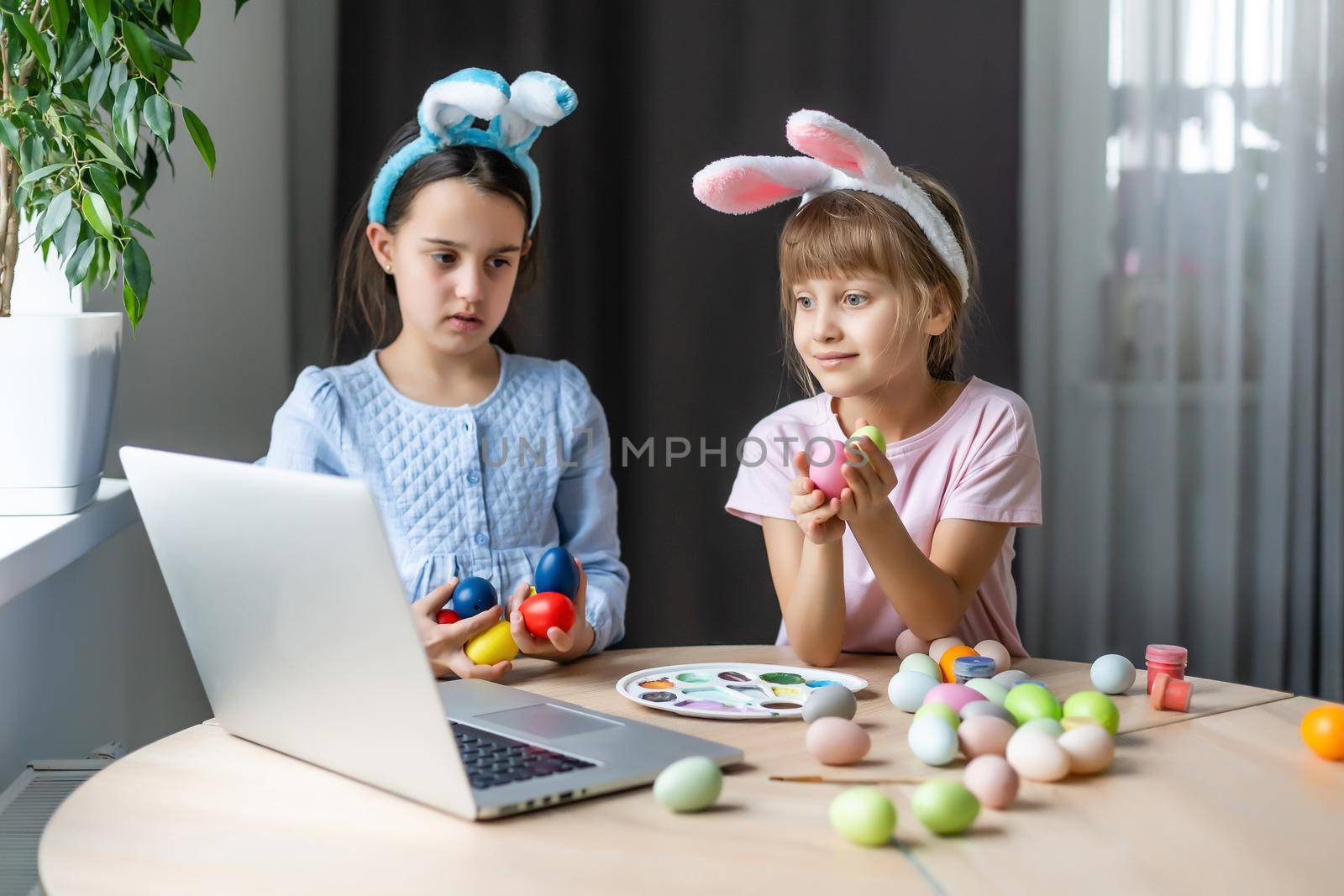 little girls for easter paint eggs, record lessons on web camera with laptop by Andelov13