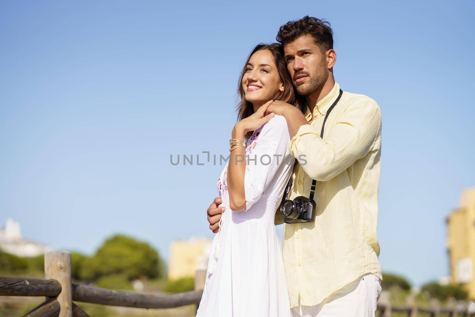 Happy loving couple looking at the horizon in a natural area