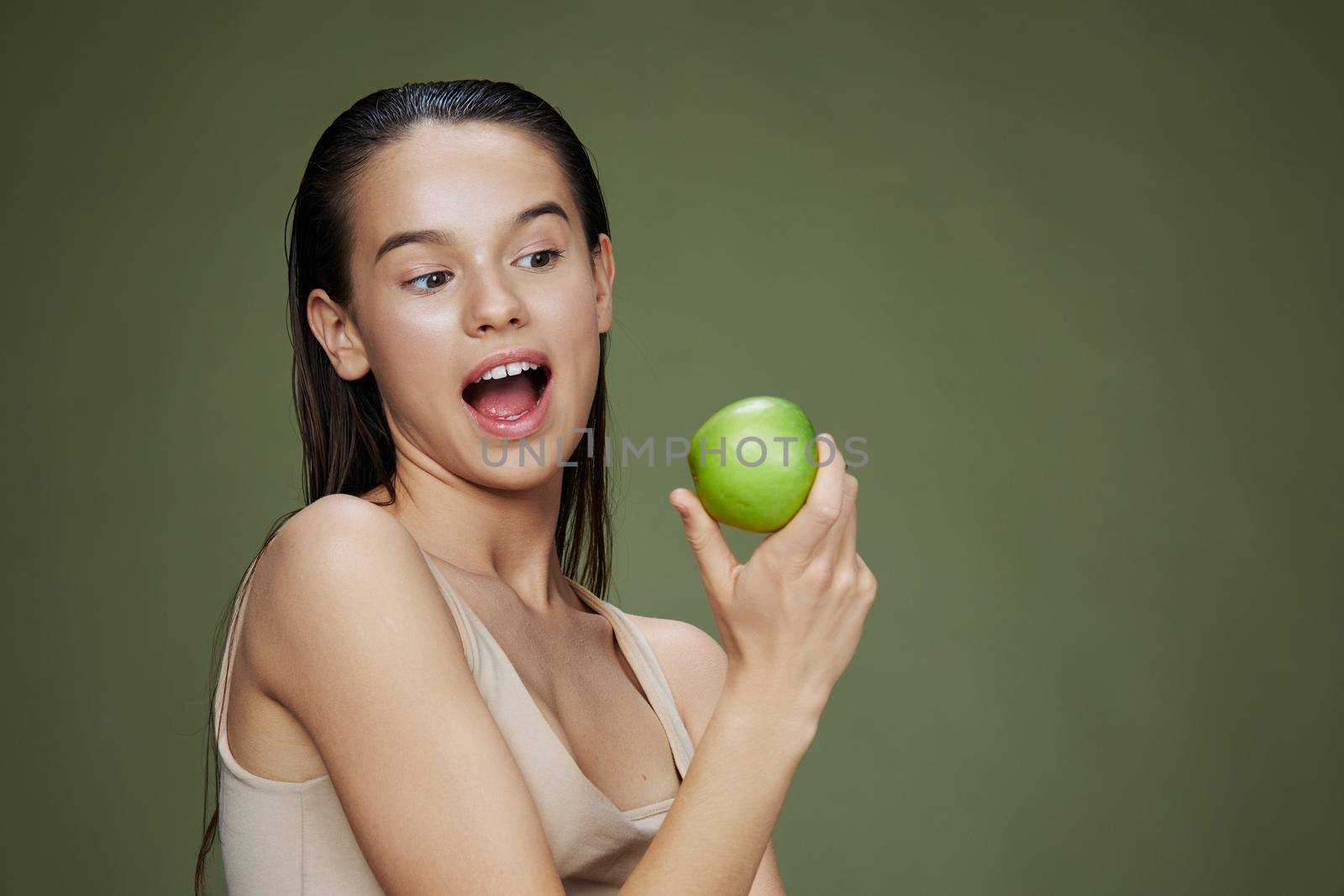 young woman with a green apple smile close-up Lifestyle by SHOTPRIME