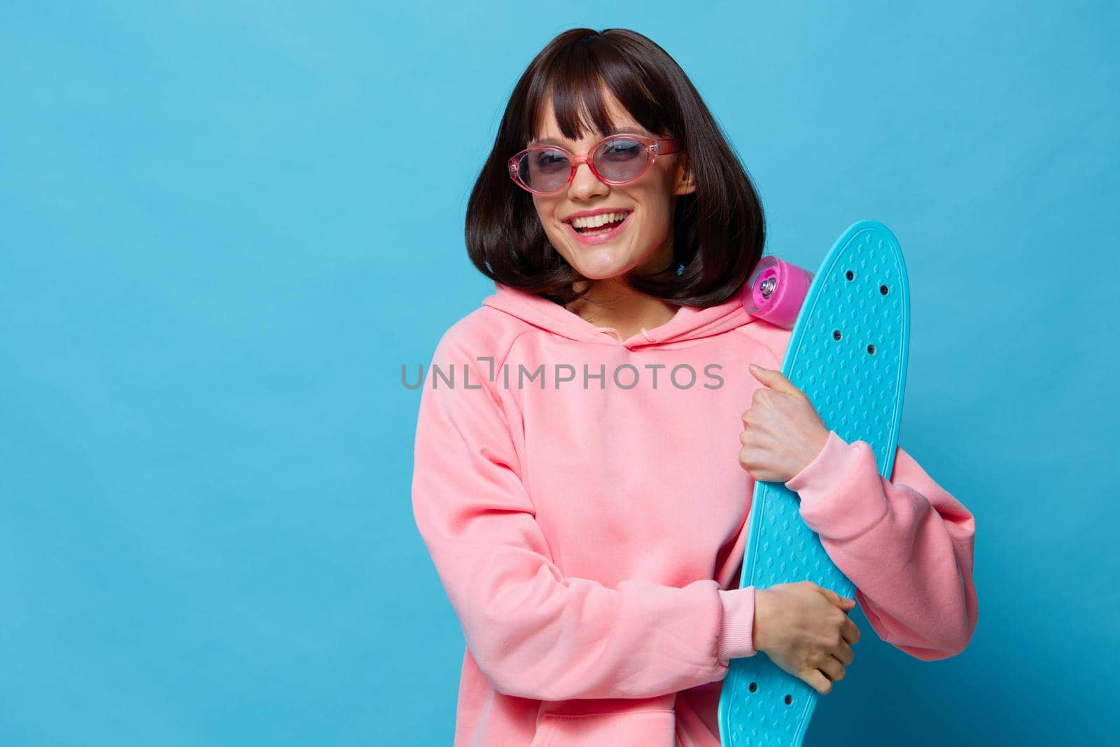 young woman in sunglasses with a skateboard Lifestyle fashion by SHOTPRIME