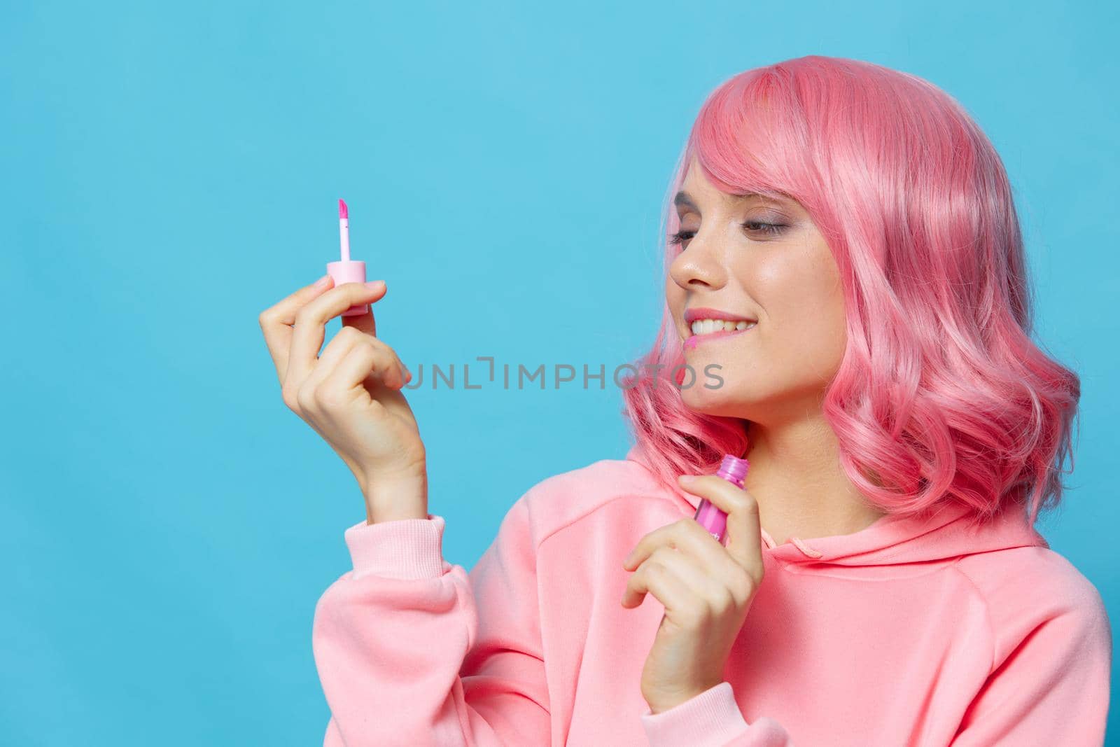 woman with pink hair lipstick makeup blue background by SHOTPRIME