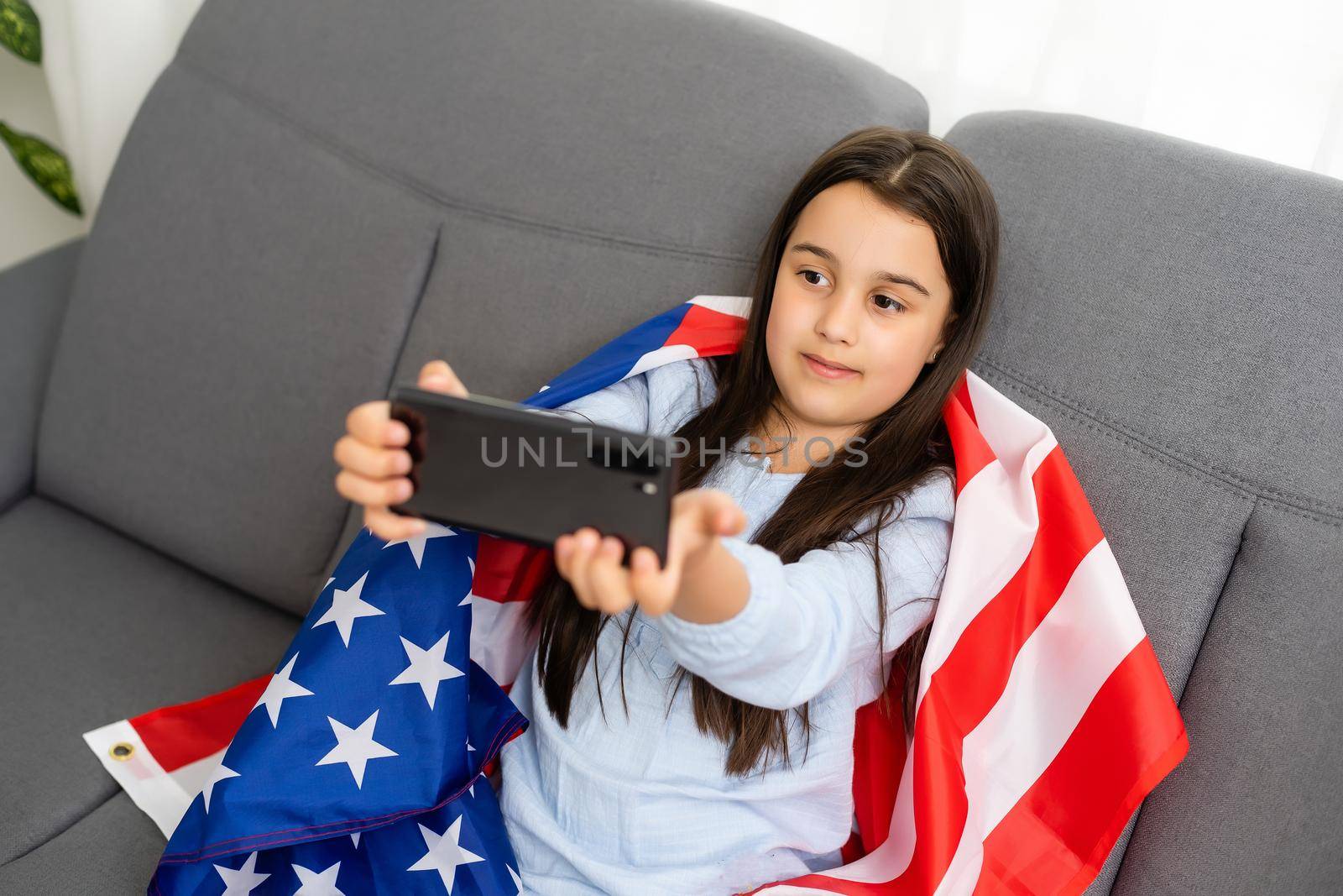 Back to online school education. Difficult to speak English. Kid doing homework on computer. Student studying on laptop over American flag. Tutor teach distantly