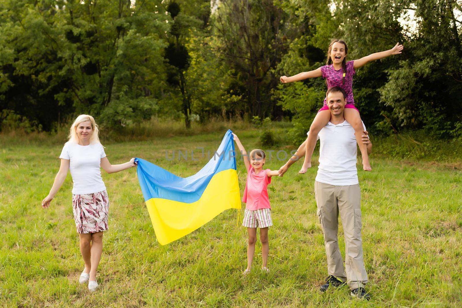 Ukraine's Independence Flag Day. Constitution day. family with the flag of ukraine in field. 24 August. Patriotic holiday. by Andelov13