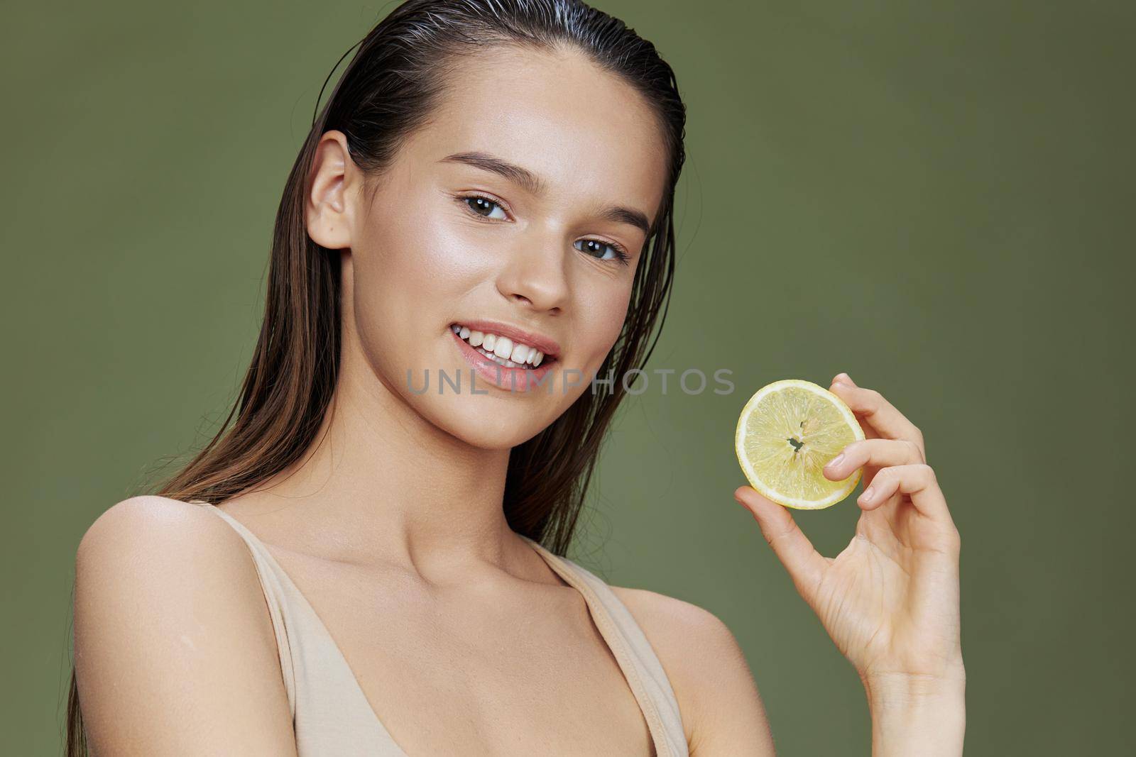 brunette lemon in hands posing clean skin close-up Lifestyle. High quality photo