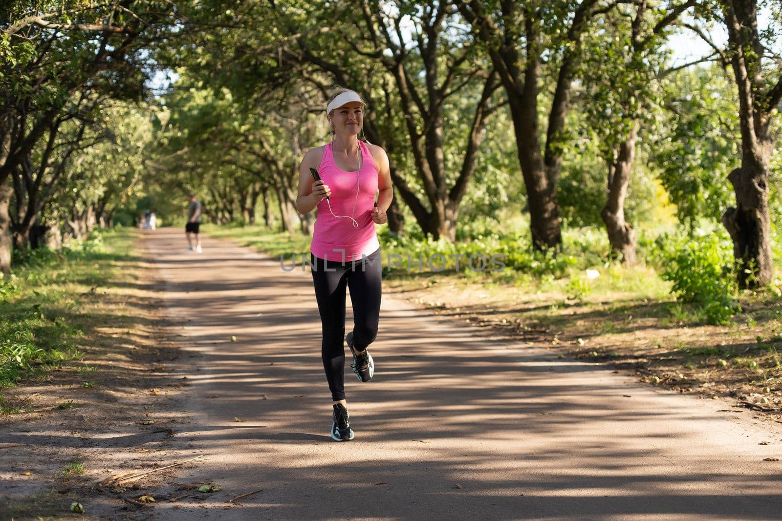 Jogging woman running in park.