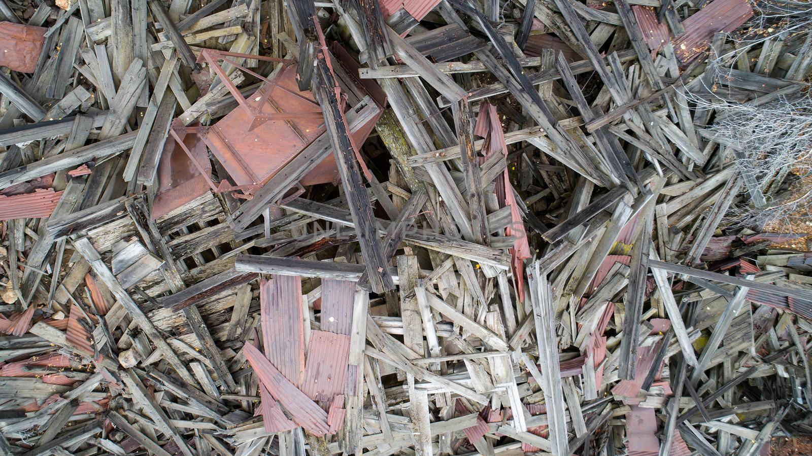 looking down on a pile of wood from a destroyed house