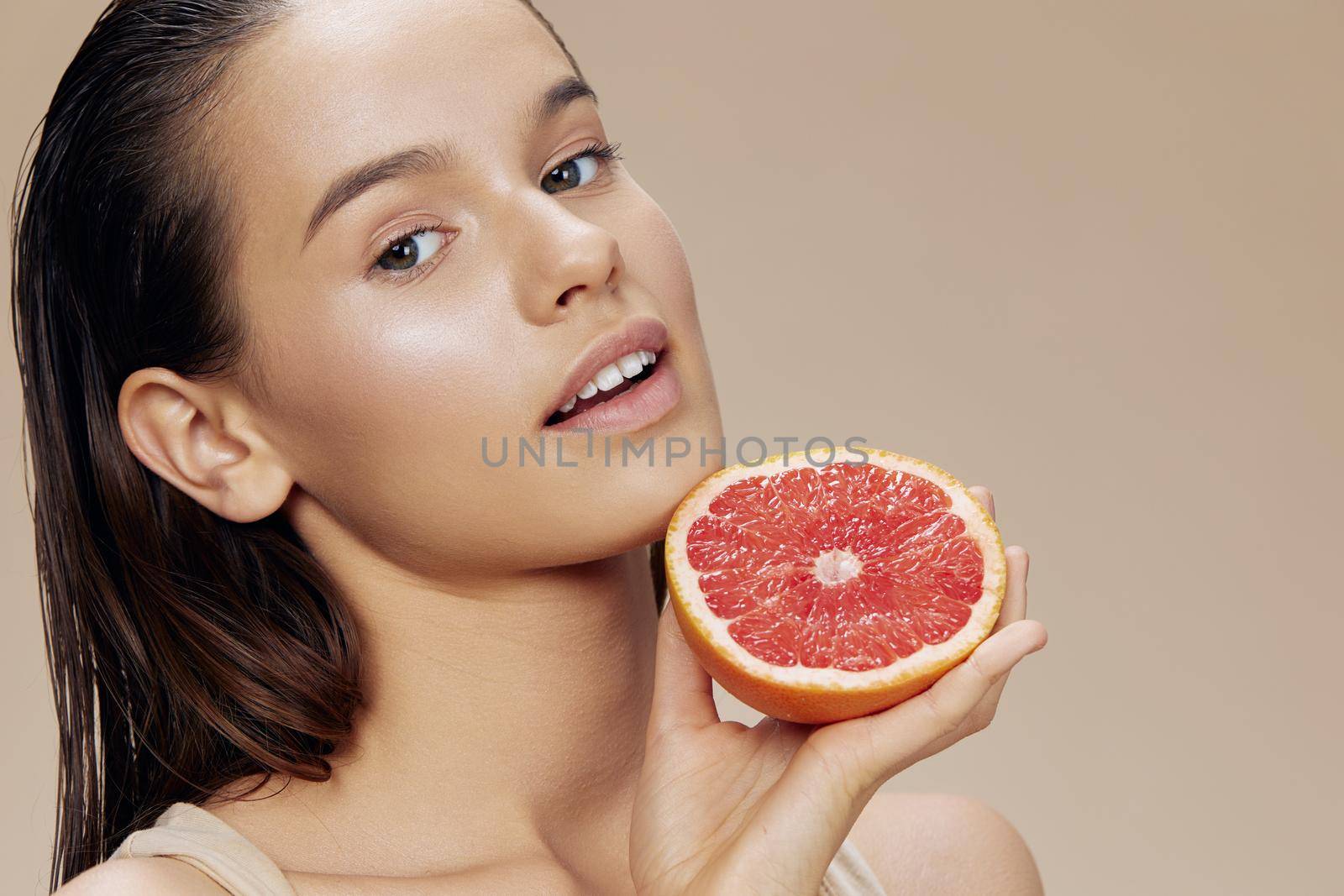 young woman grapefruit near face clean skin care health isolated background. High quality photo