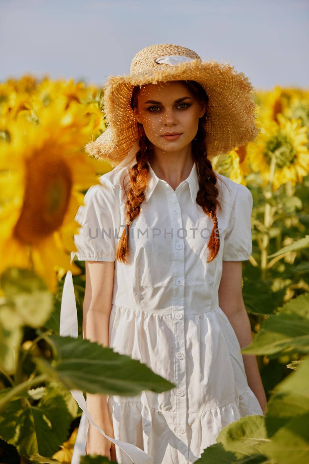 woman with pigtails in a hat on a field of sunflowers Summer time by SHOTPRIME