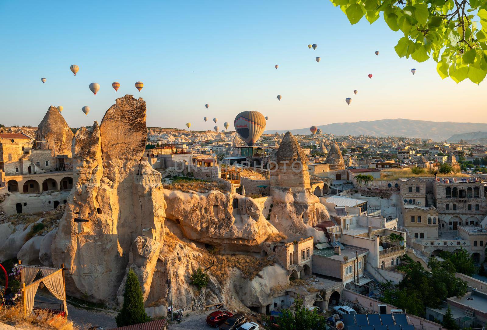 Hot air balloons over rocks in Cappadocia