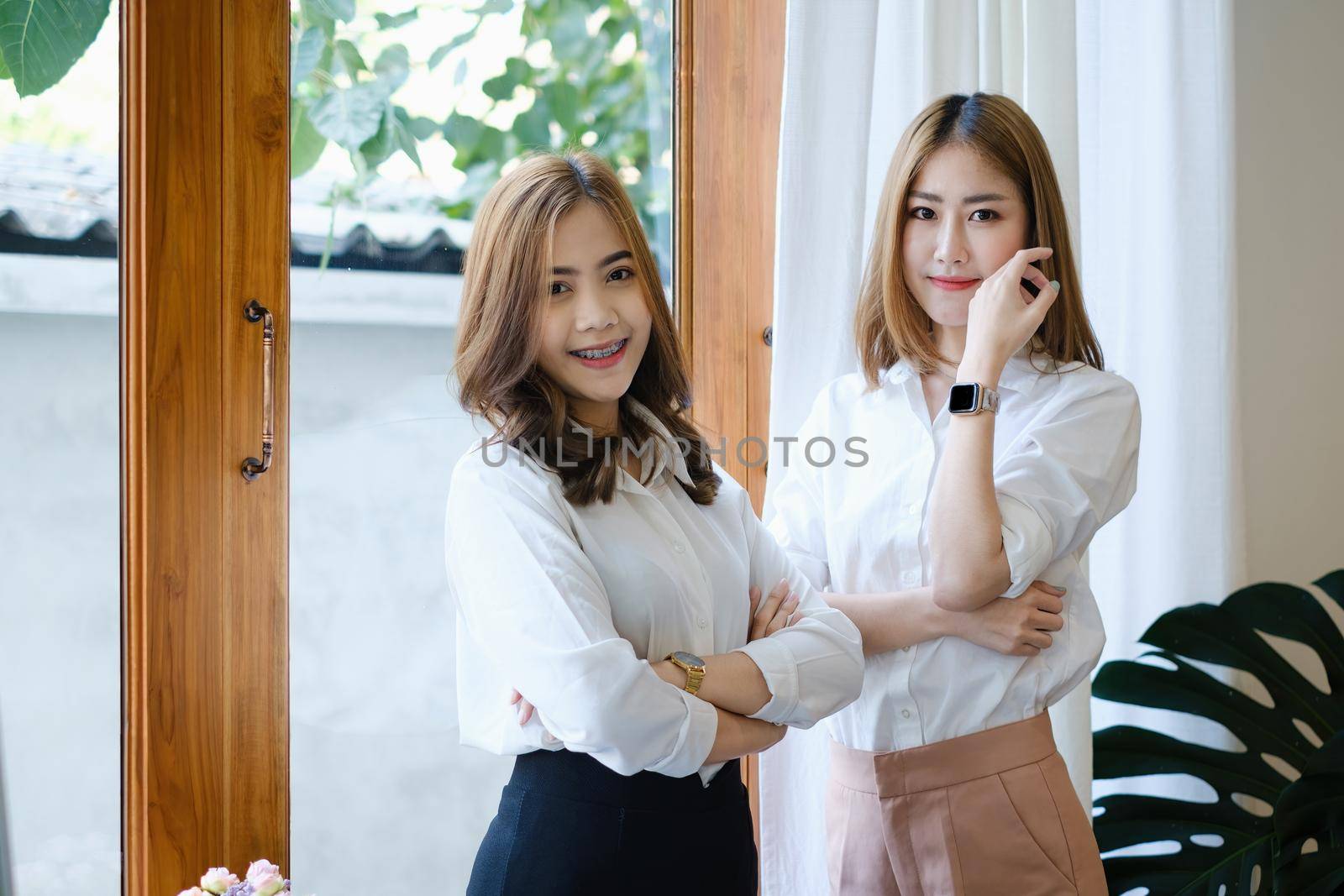 Smiling and happy Asian businesswoman working together in office. Finance and Accounting concept