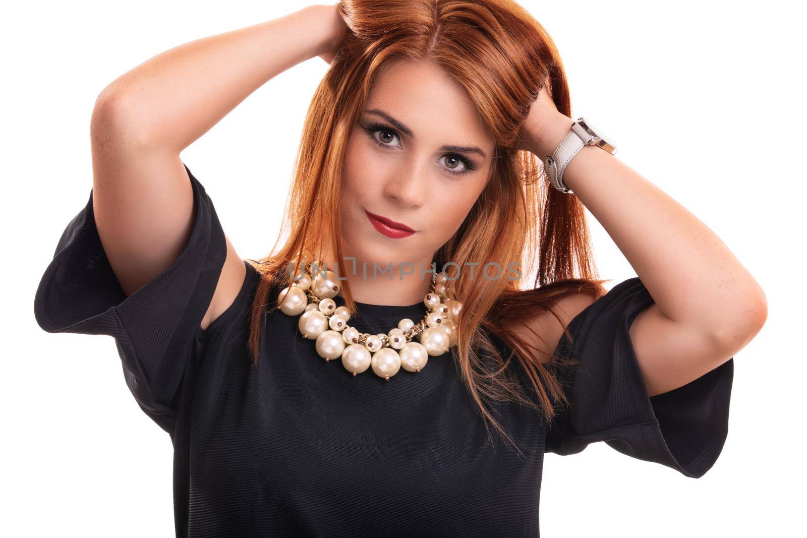 Portrait of a beautiful smiling young redhead woman with hands in her hair, isolated on white background. Beauty, wellness, people, healthy lifestyle, fashion model, skin and hair care concept