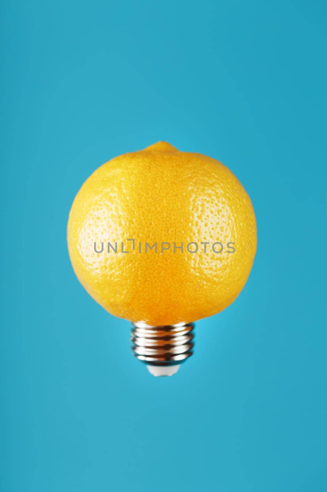 Light bulb lemon in flight on a blue background. The conceptual idea. Free space