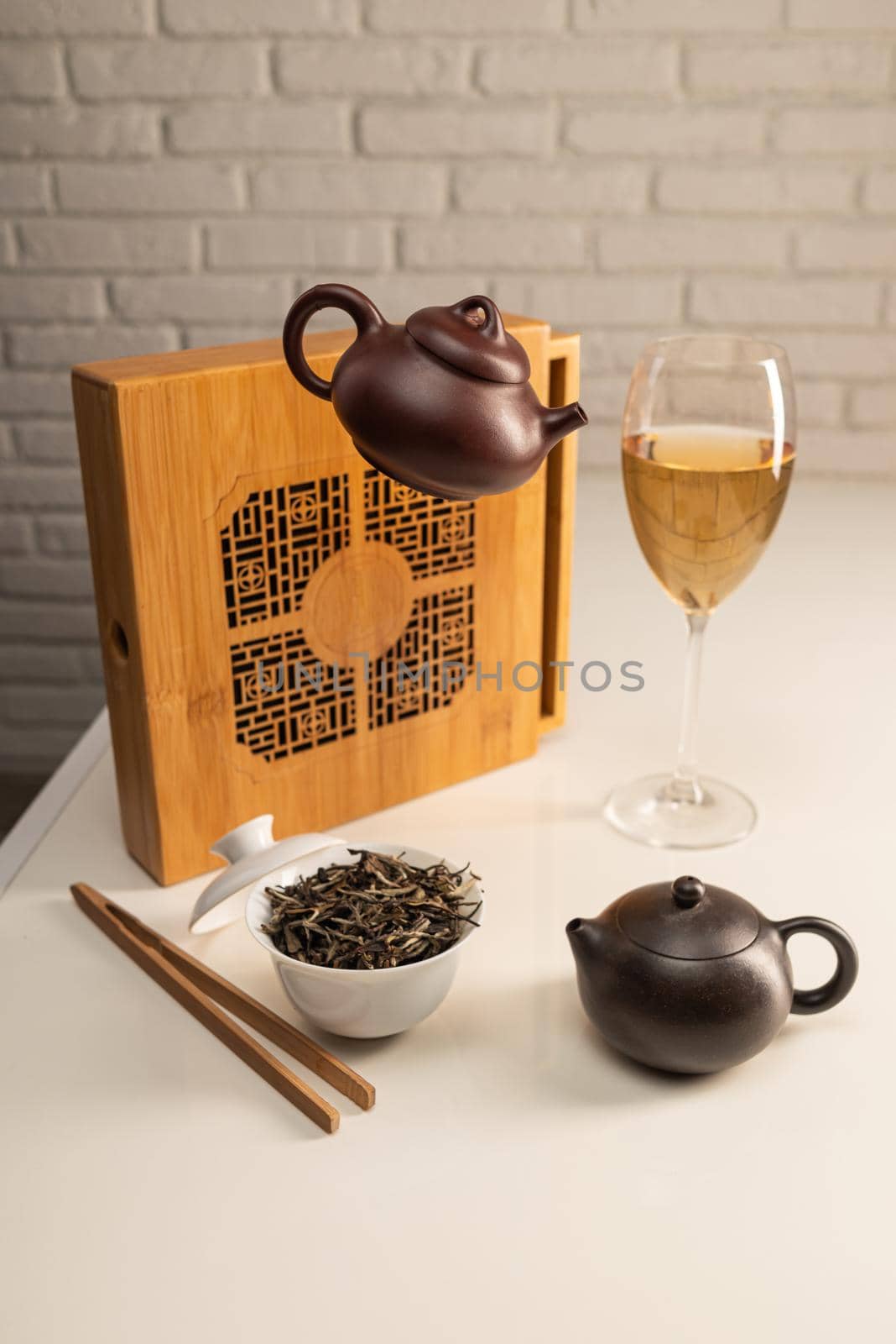 tea table with appliances and wine glasses, in which large-leaf tea is brewed