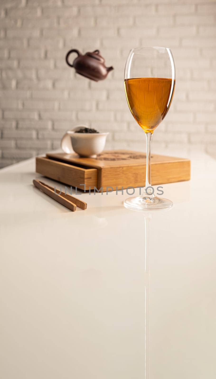 tea table with appliances and wine glasses, in which large-leaf tea is brewed