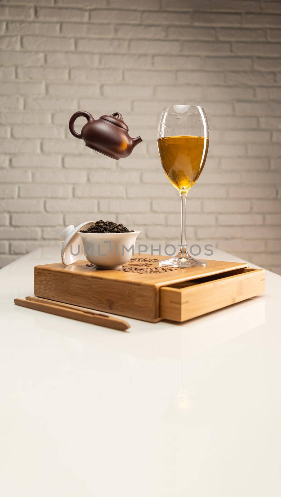 tea table with appliances and wine glasses, in which large-leaf tea is brewed by Rotozey