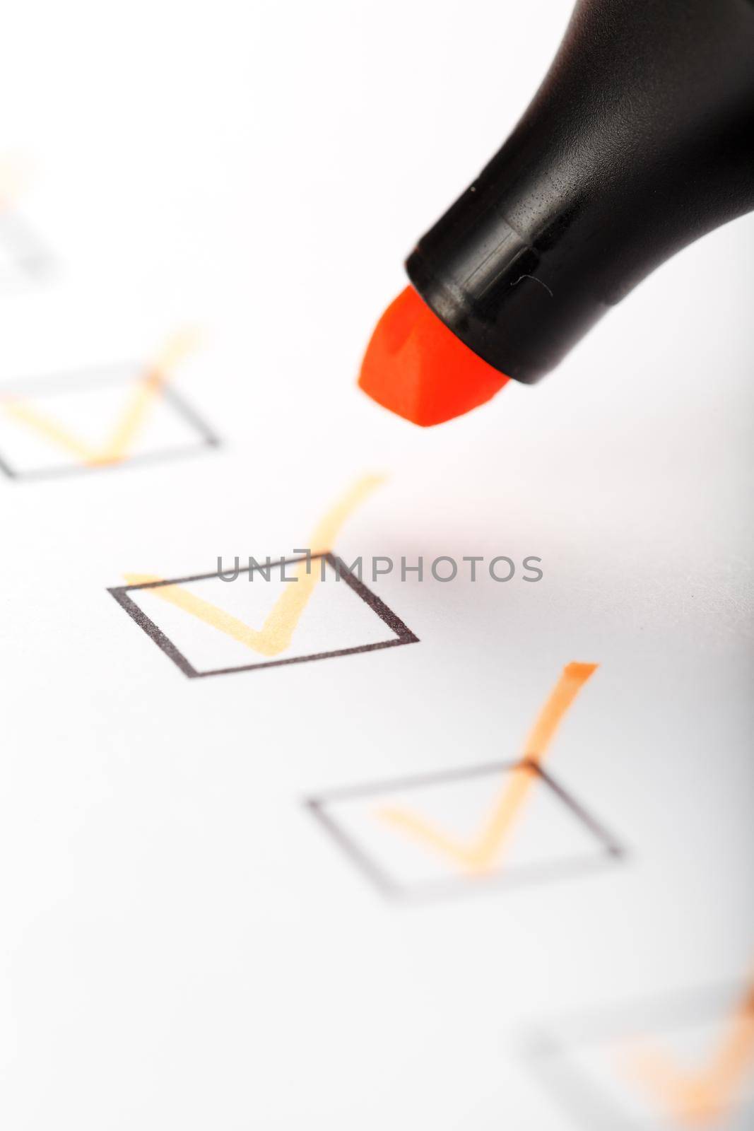 Orange marker with markers on the checklist sheet. Checklist completed task concept.