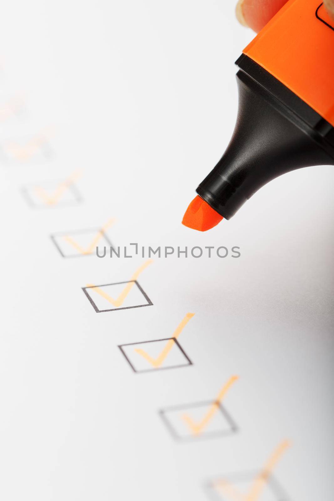 Orange marker with markers on the checklist sheet. by AlexGrec