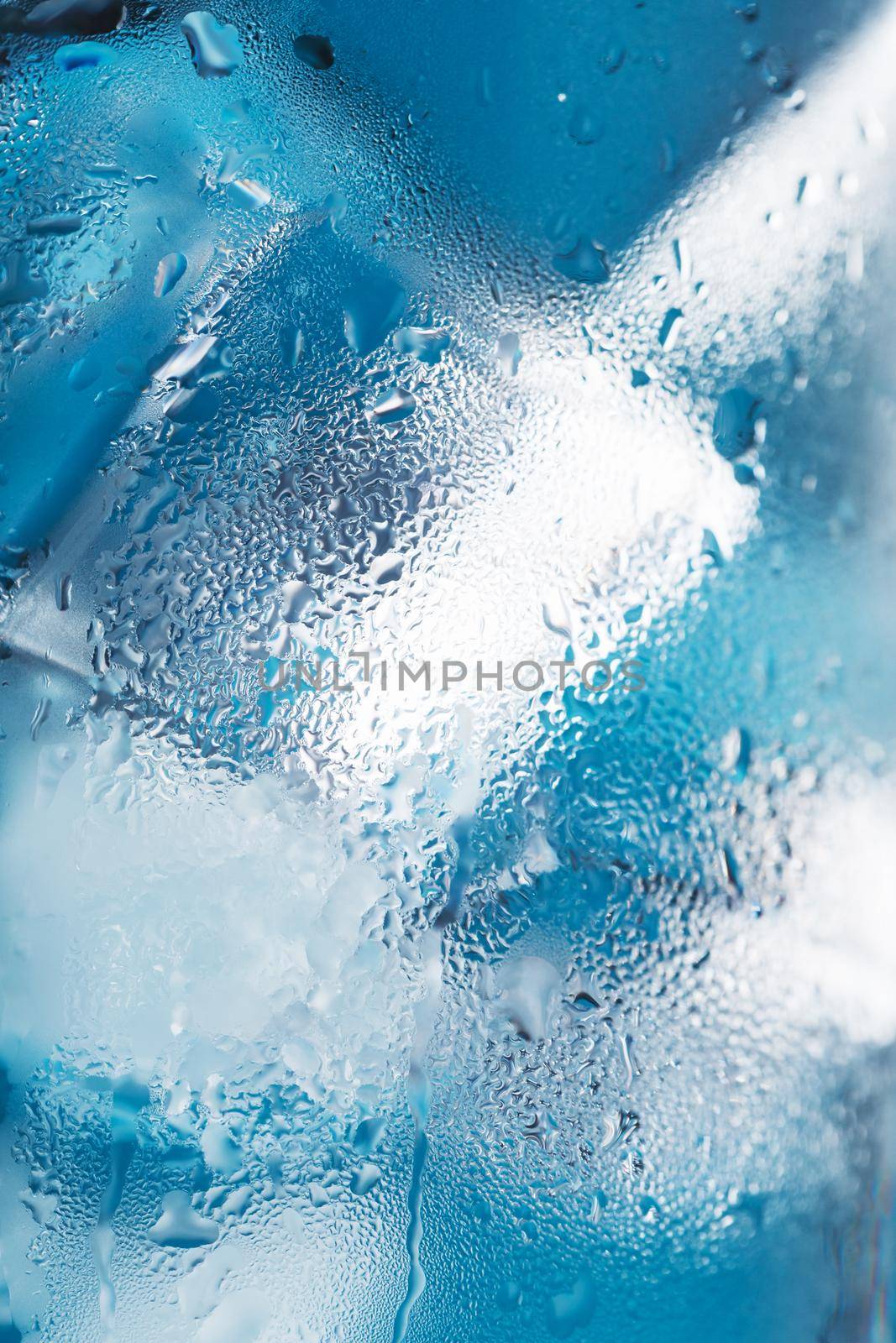 Ice cubes in a misted glass with drops of ice water close-up macro. Soft Selective Focus by AlexGrec