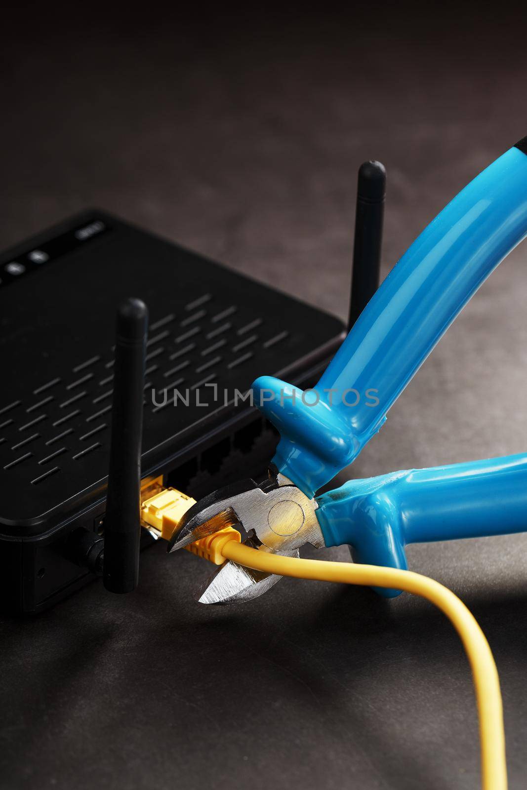 Cutting and disconnecting the network Internet connection with cutting pliers. Disabling the Wi-Fi router network. Life without internet. Disconnection for non-payment