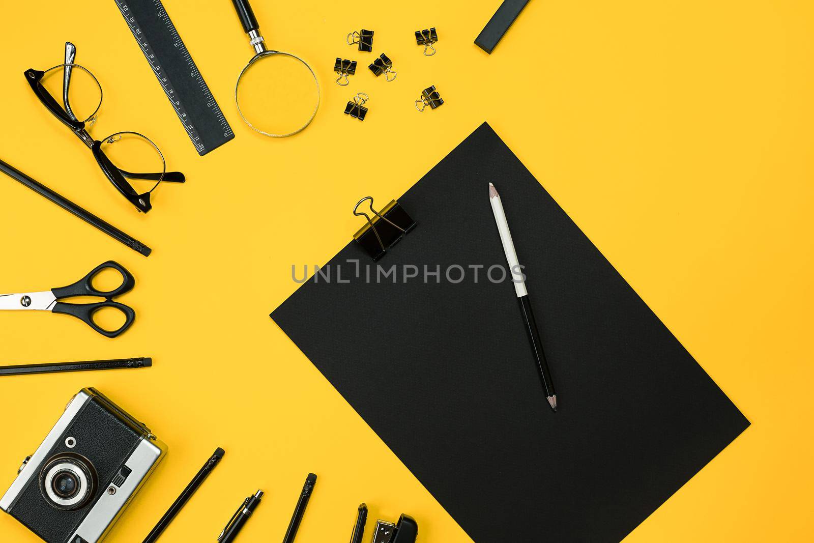 Workplace with office items and business elements on a yellow background. Concept for branding. Top view. Copy space. Still life