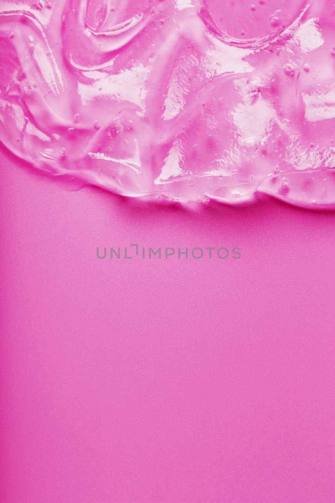 Transparent liquid gel on a pink background with free space. Antiseptic, cosmetic gel