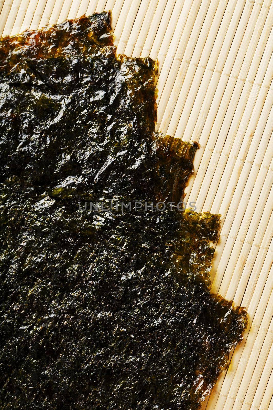 Nori algae leaves on a bamboo substrate. The main ingredient for sushi rolls. Top view