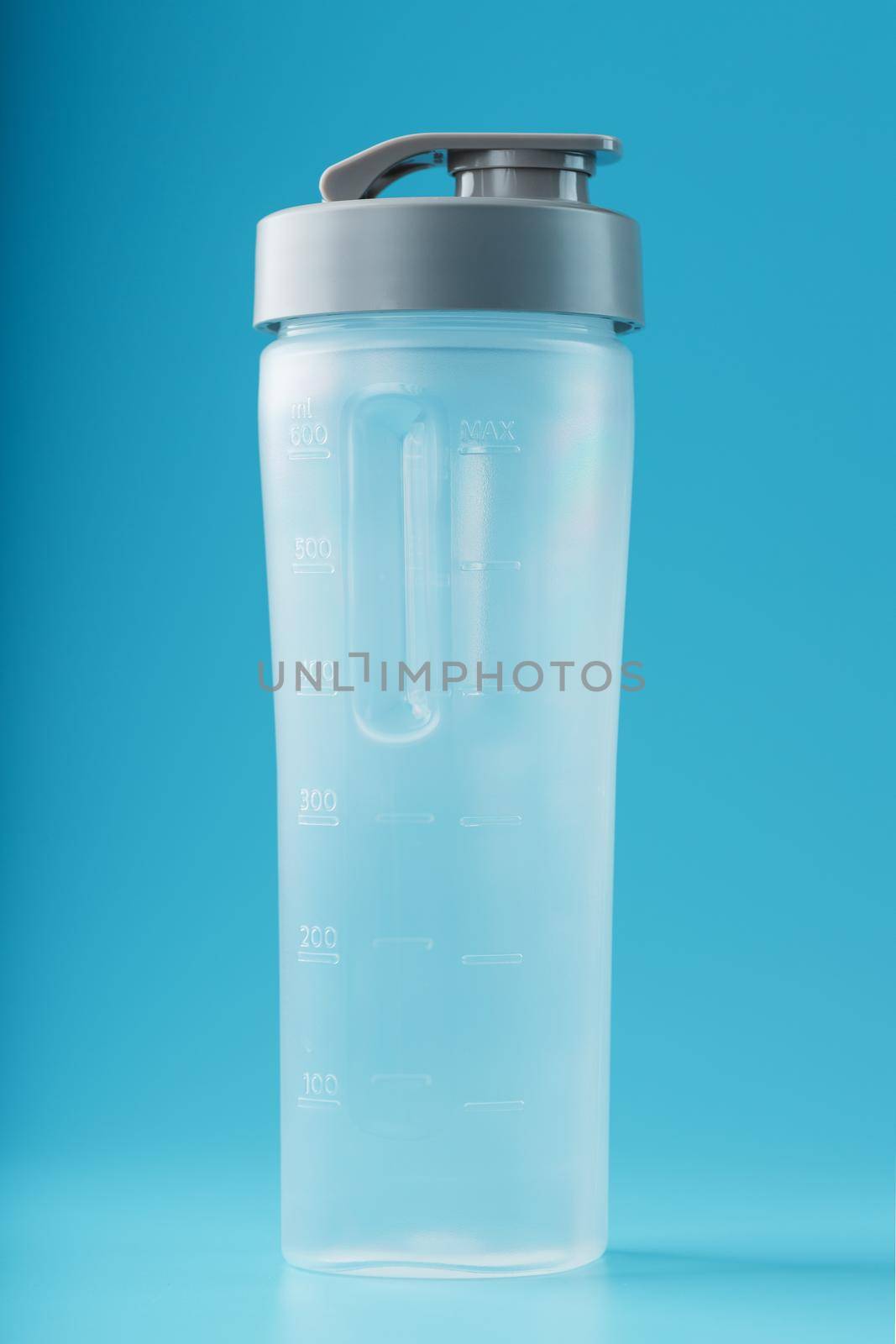 Shaker is an empty plastic smoothie cup on a blue background. by AlexGrec