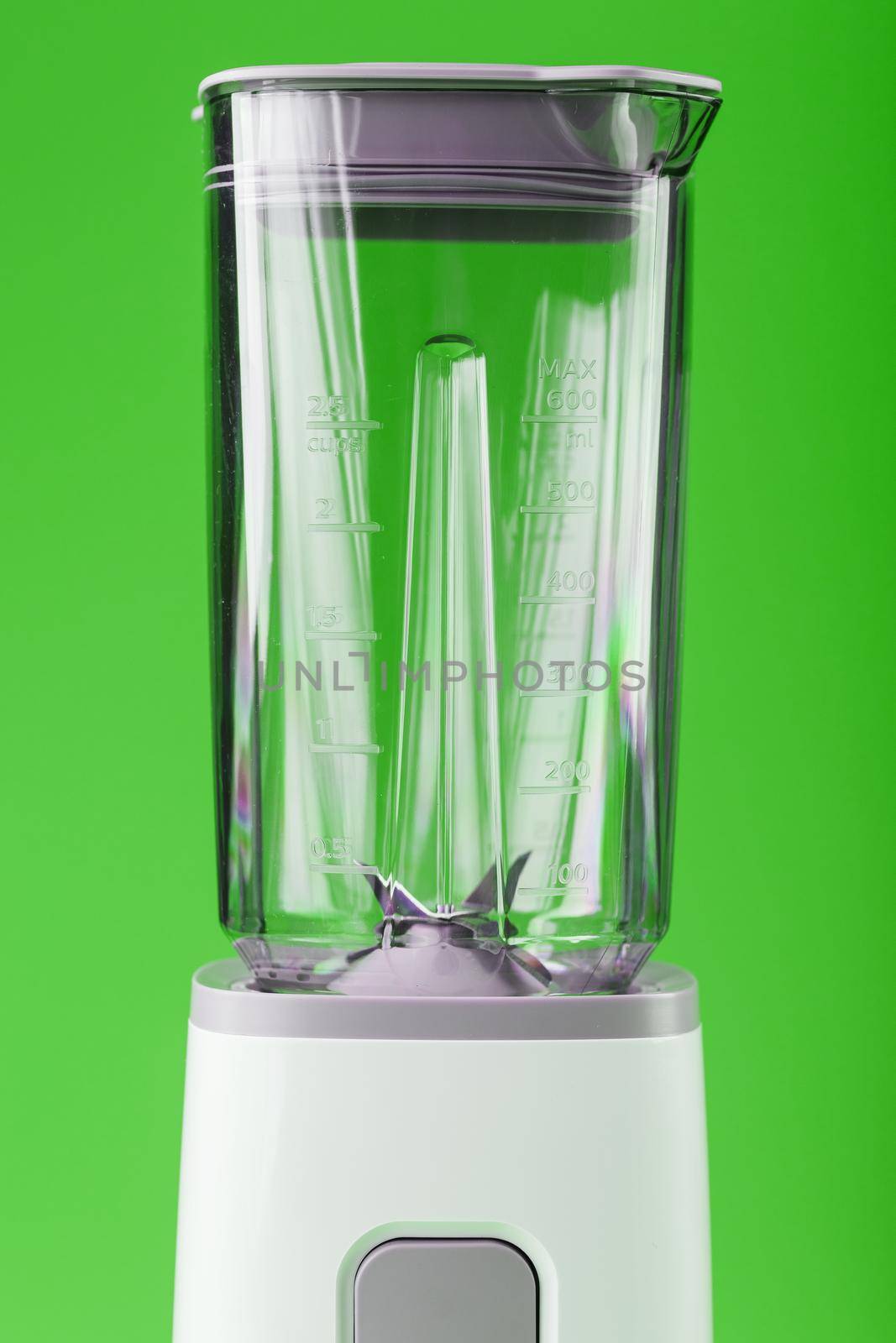 A white blender with an empty glass on a green background. by AlexGrec