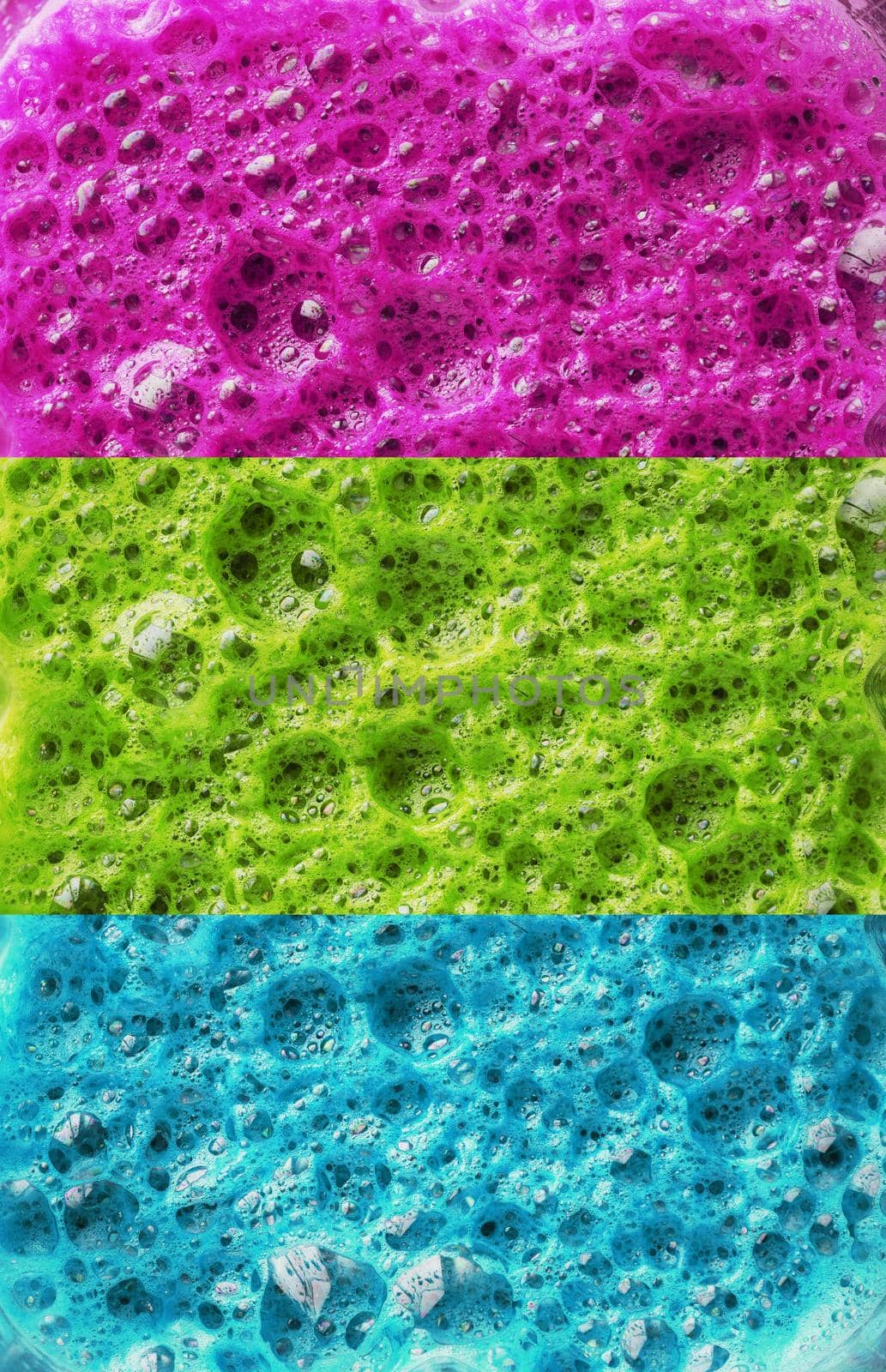 Multi-colored foam of three colors, pink, green and blue in a row. Conceptual color background