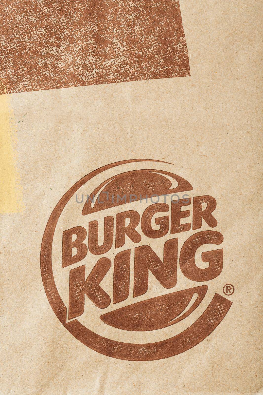 Russia, Moscow - May 17, 2021: Paper bag with Burger King logo. Burger King is a global fast food hamburger chain with headquarters worldwide by AlexGrec