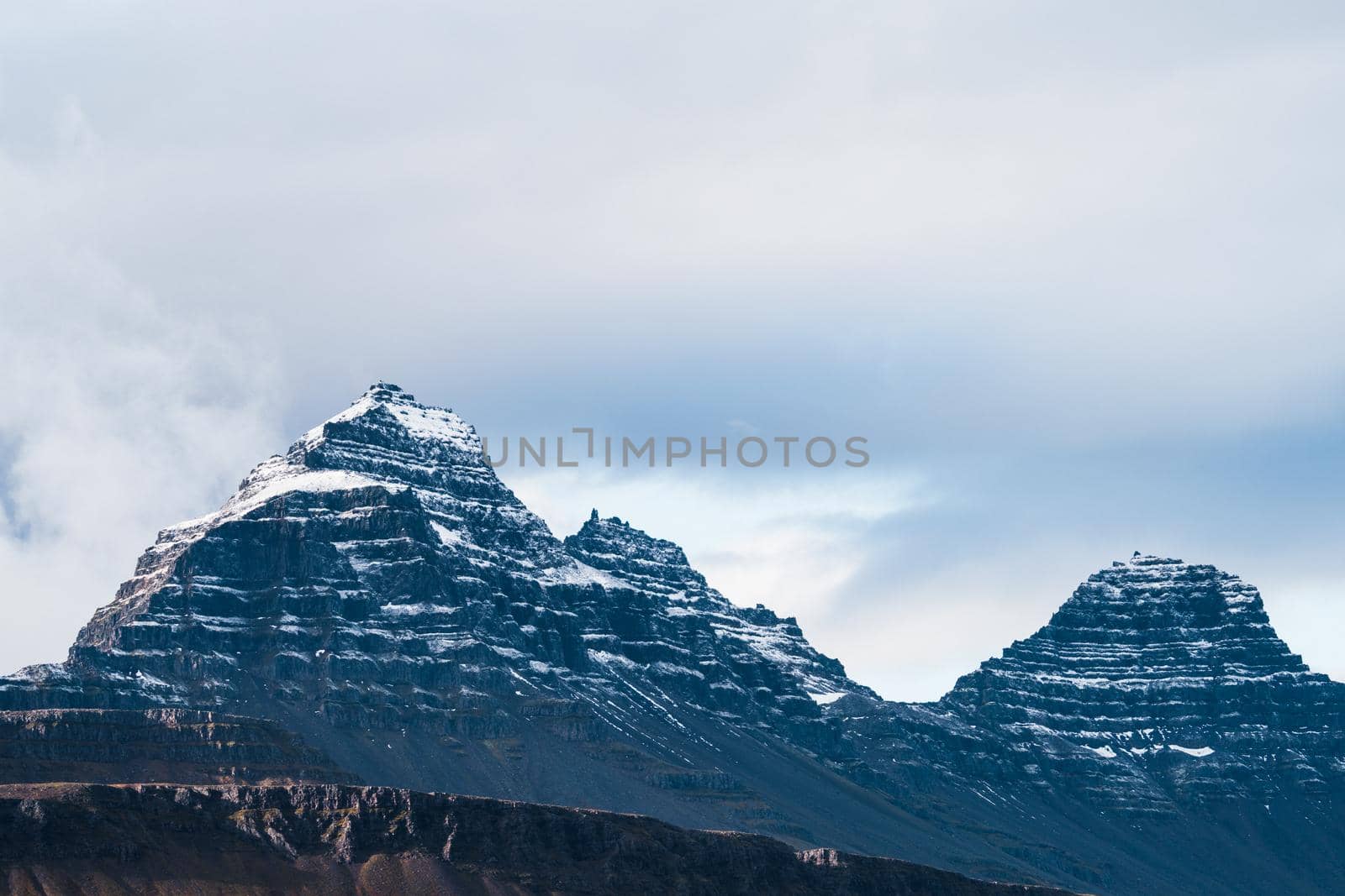 Sharp dark mountain peaks covered by snow by FerradalFCG