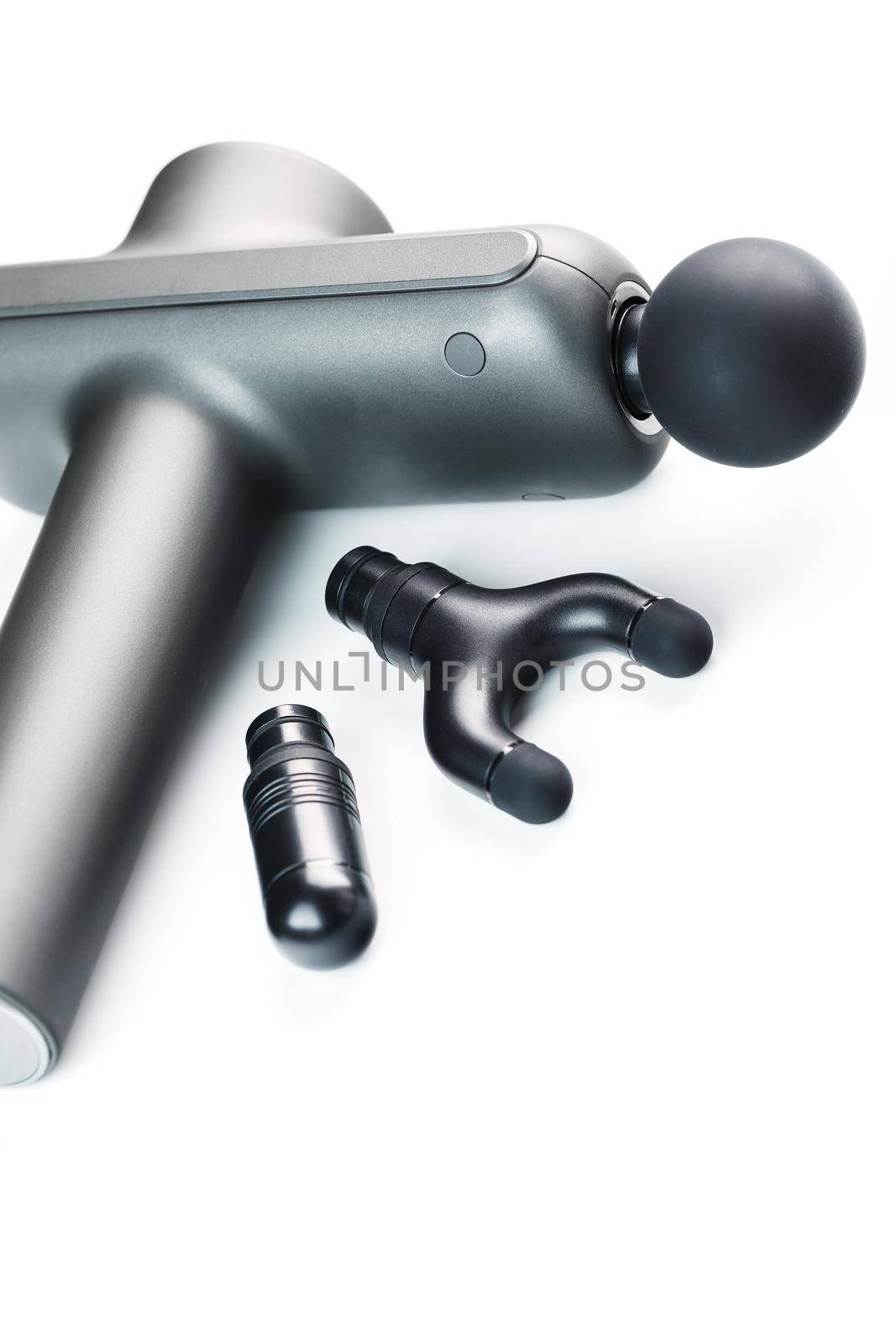 Electric body massager with various attachments on a white background. Isolate