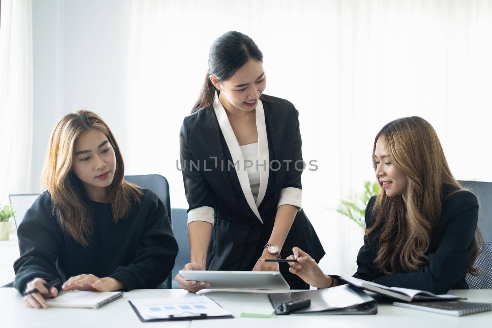 Business people meeting and analyst financial advisor preparing statistical report searching documents on work desk, browsing information online by digital tablet. by itchaznong
