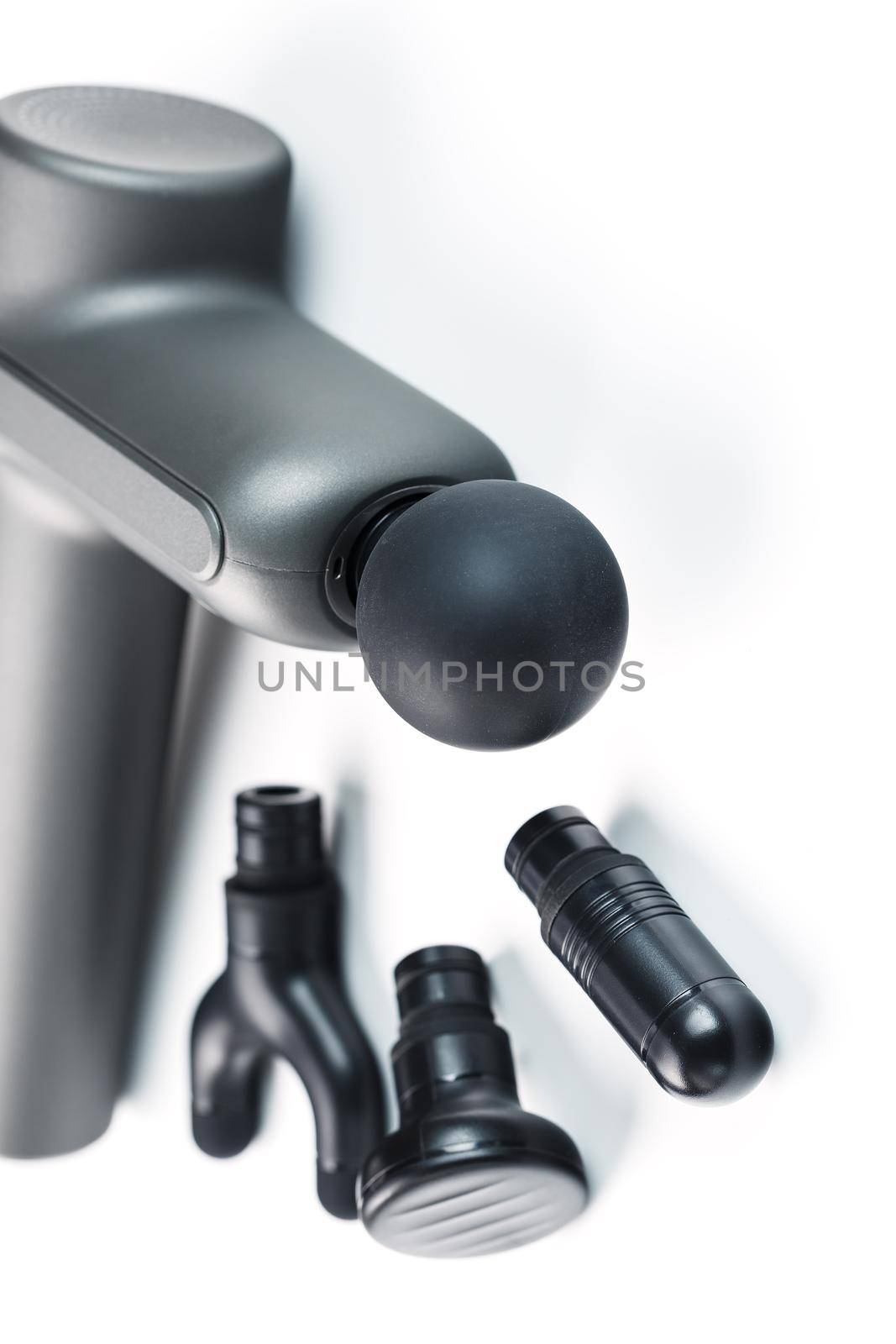 Electric body massager with various attachments on a white background. by AlexGrec