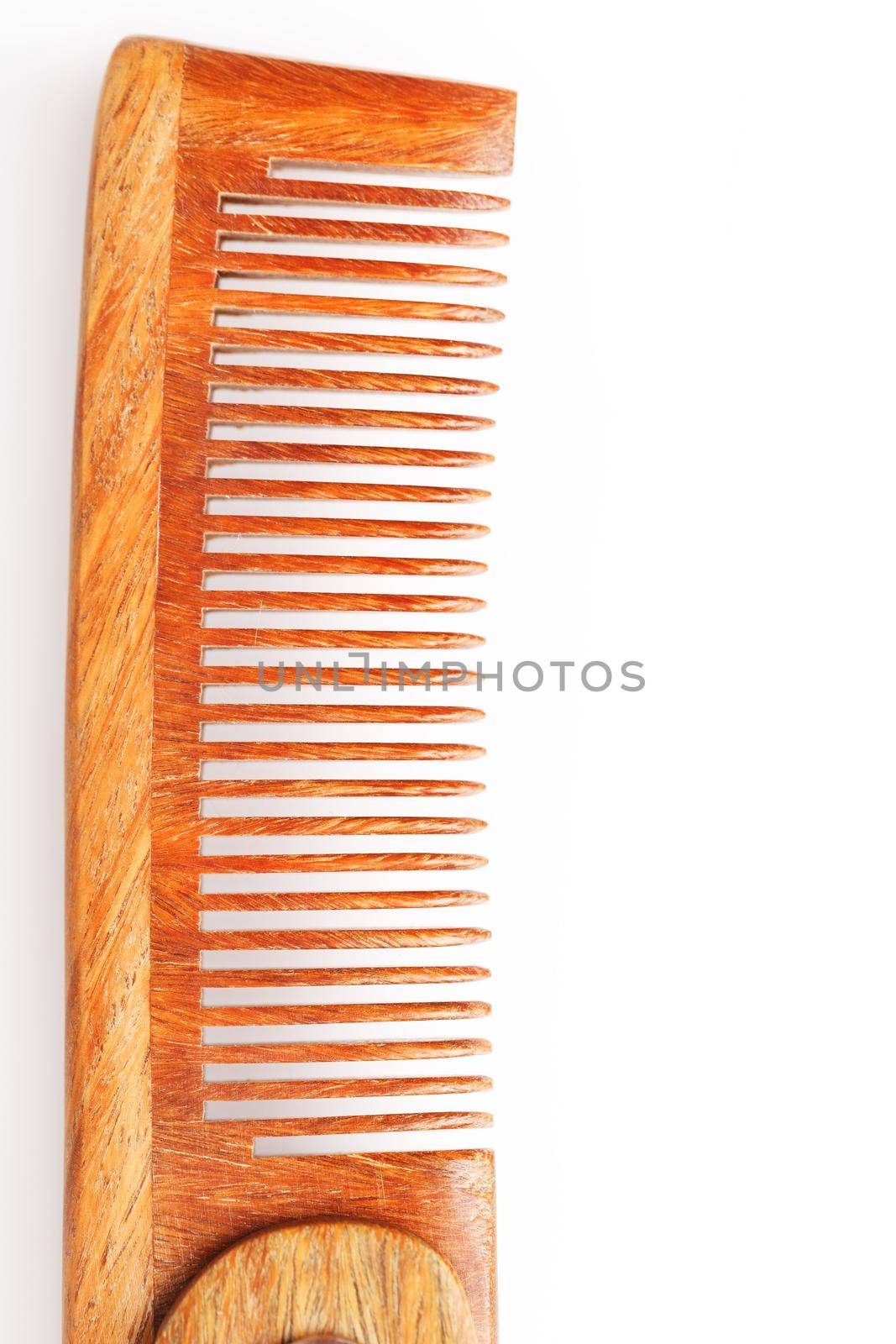 Folding wooden comb on a white background. by AlexGrec