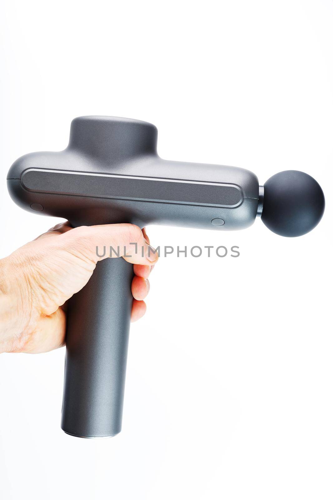 Manual electric body massager in hand on a white background. Isolate