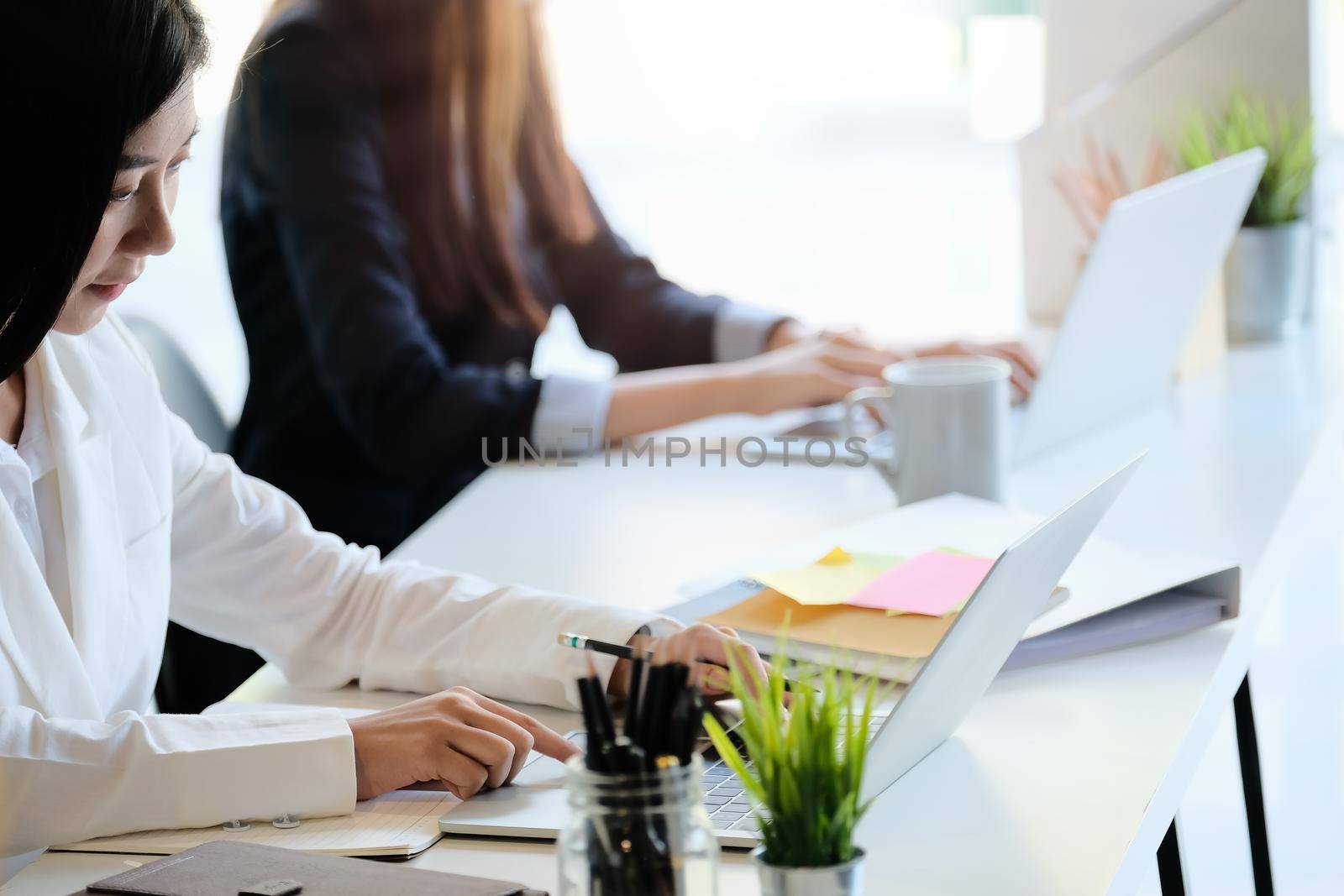 Business team use laptop computer for marketing planing on workplace in modern office.