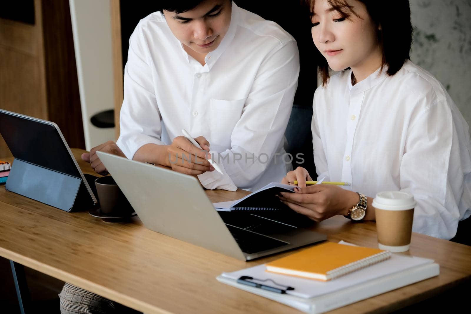 Business team brainstorming and discussing financial report graph with laptop computer. Teamwork meeting working concept.