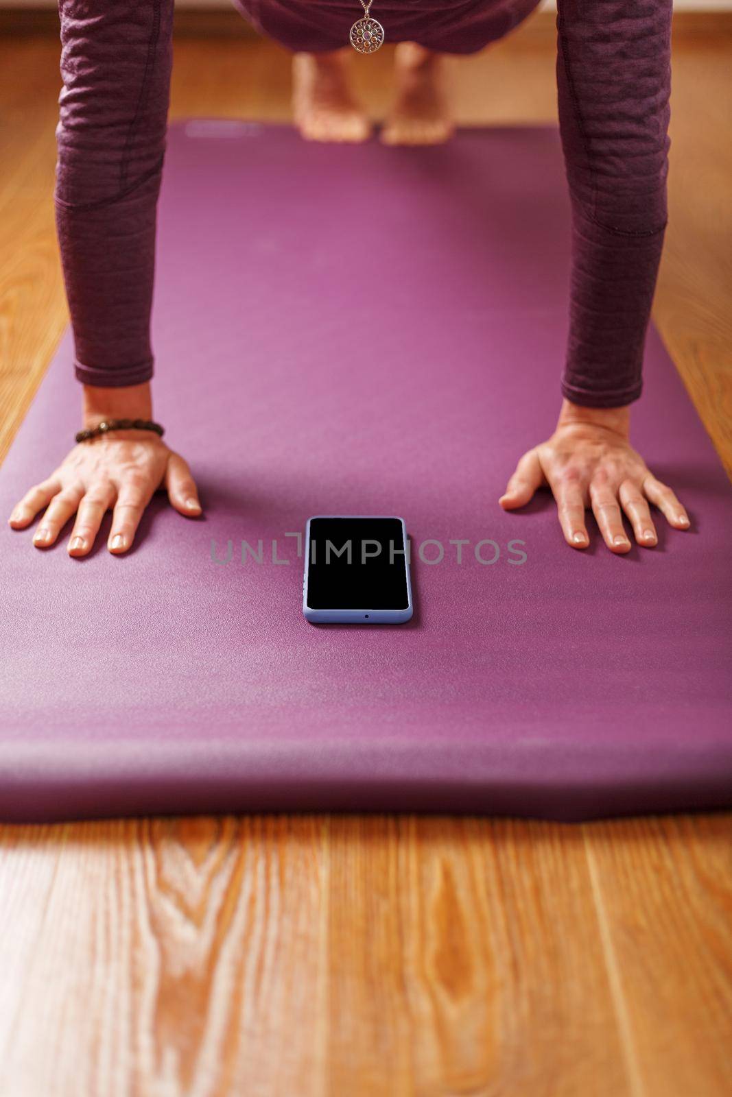 Yoga online training workout by smartphone, using the fitness app at home in the gym. Online yoga and meditation practices. Place on the smartphone screen