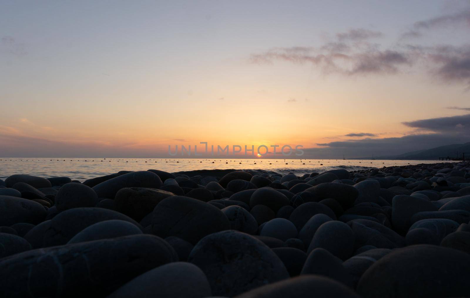 Amazing beach sunset over Black Sea. Lazarevskoye, Sochi, Krasnodar Krai, Russia