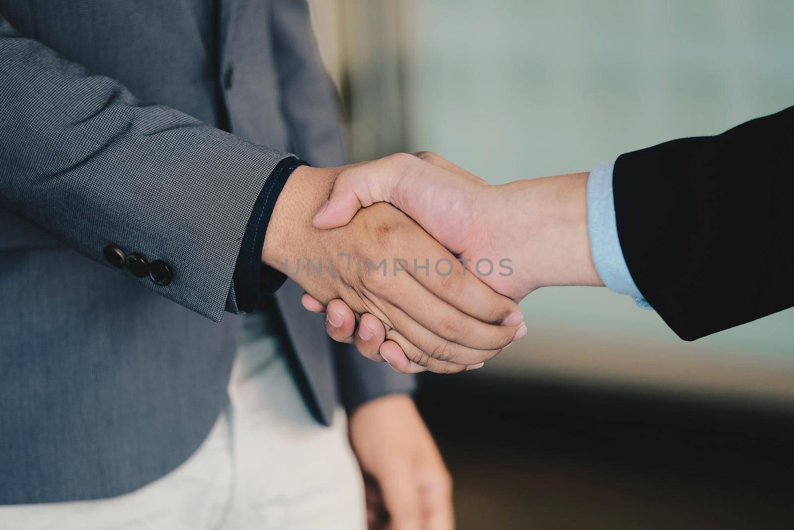 Close up of Business people shaking hands, finishing up meeting, business etiquette, congratulation, merger and acquisition concept.