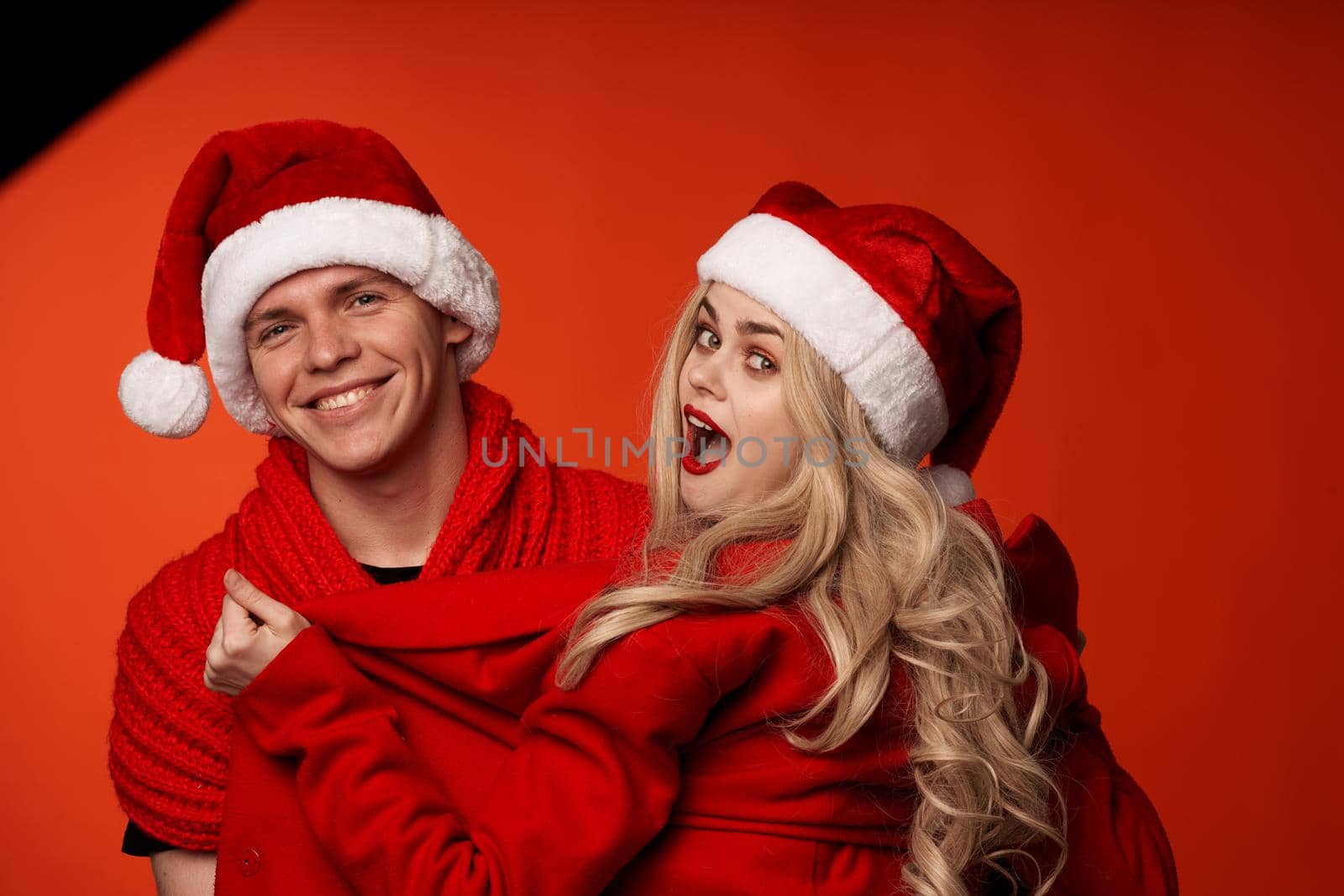Man and woman in santa hats fun new year holiday isolated background by SHOTPRIME