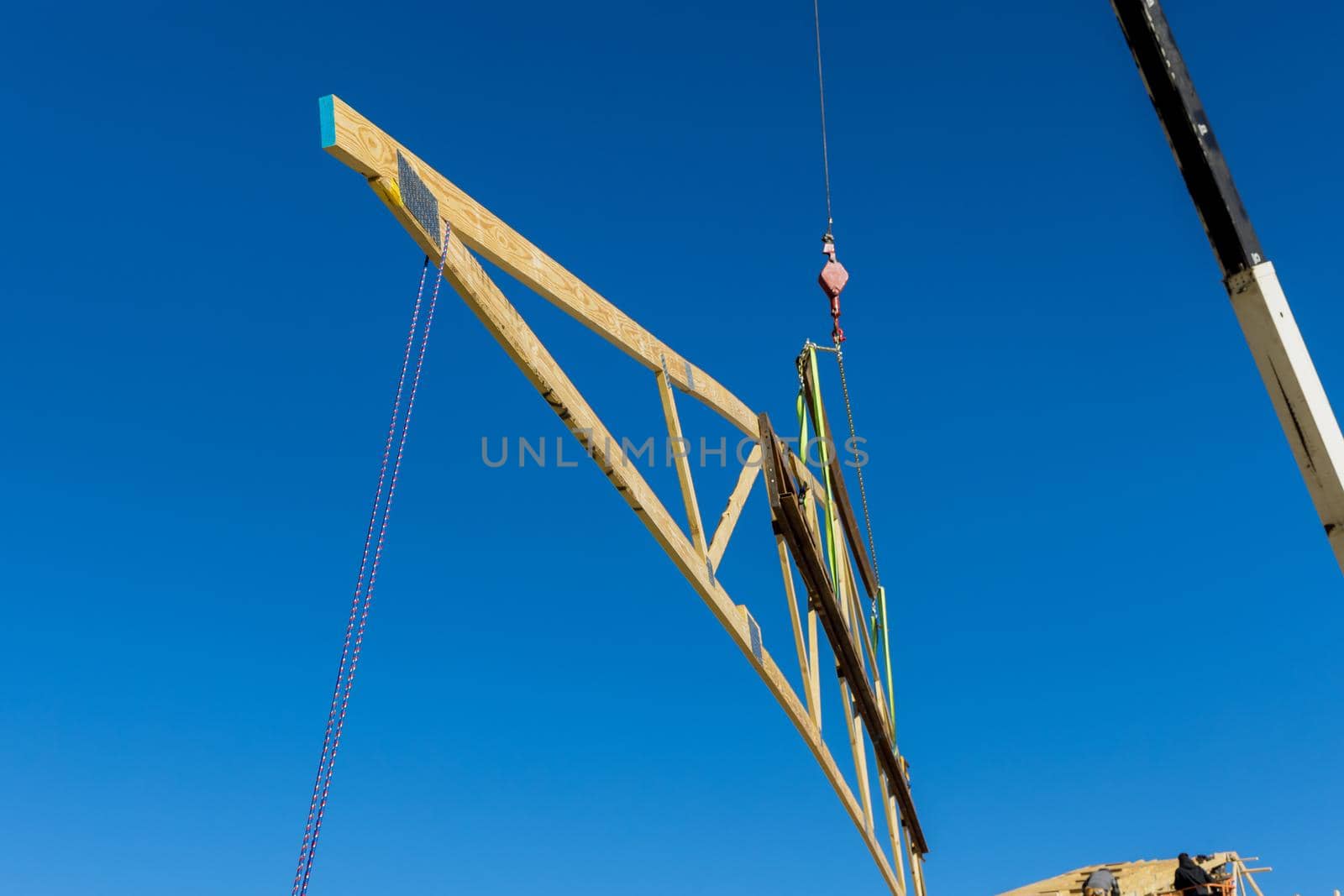 New residential construction home framing against a crane holds is new in wood roofing by ungvar