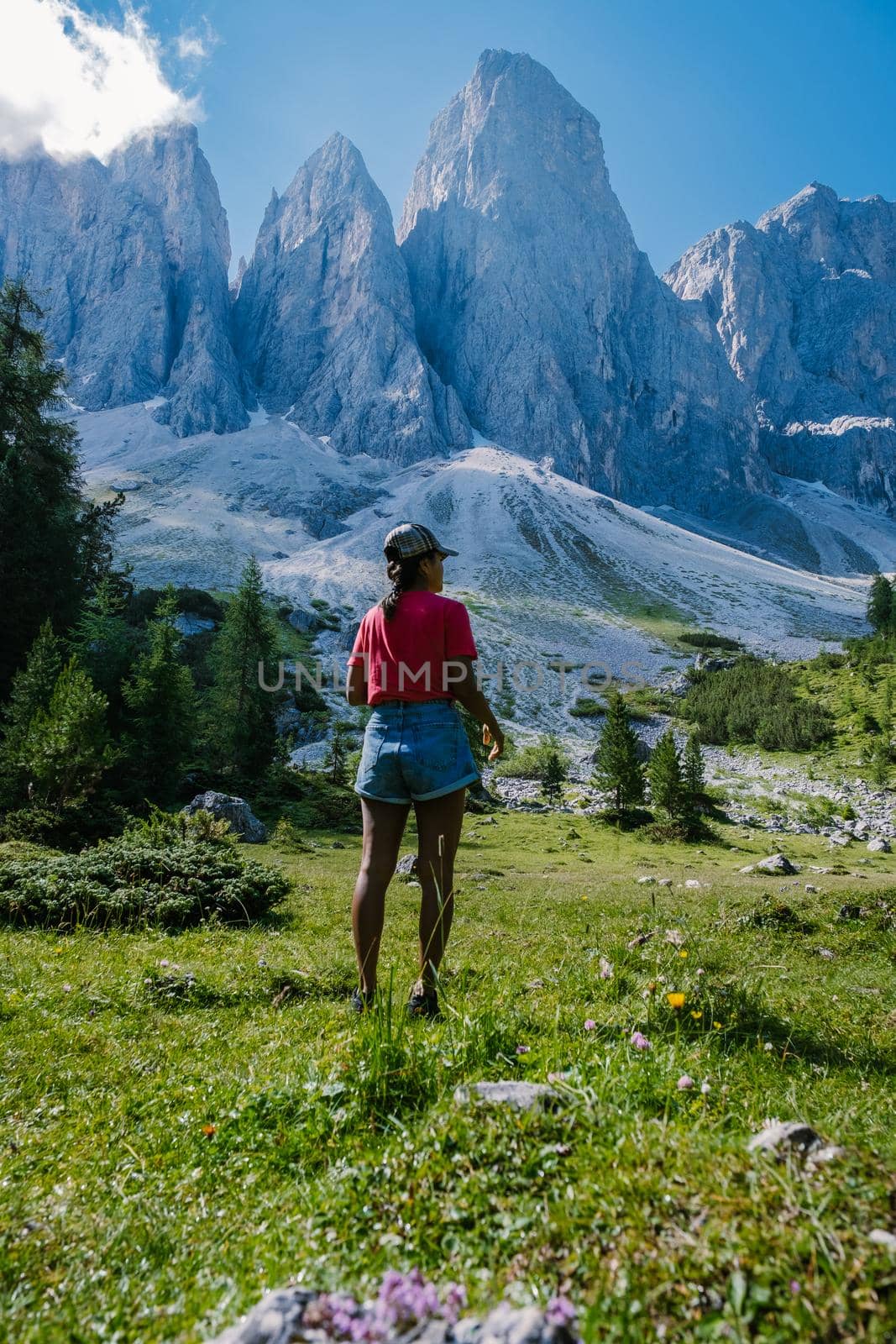 Geisler Alm, Dolomites Italy, hiking in the mountains of Val Di Funes in Italian Dolomites,Nature Park Geisler-Puez with Geisler Alm in South Tyrol. Italy Europe, woman hiking in moutains summer