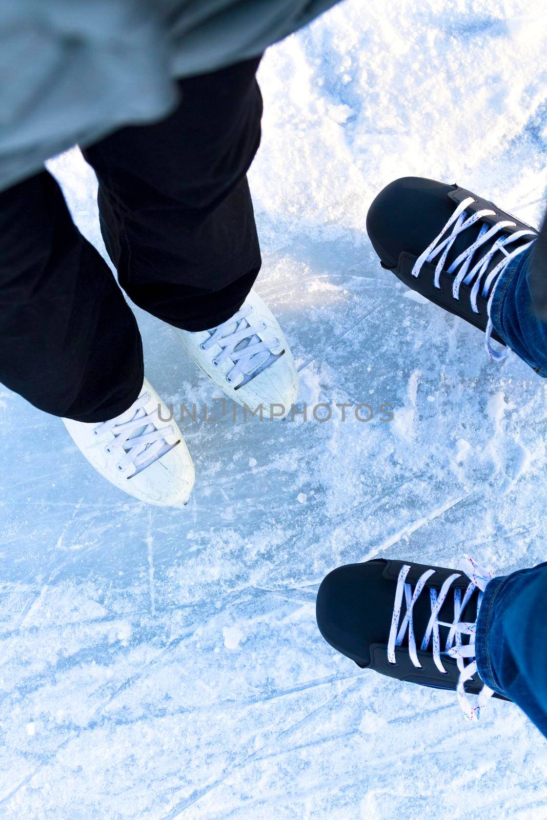 Woman and man together on the ice rink. Winter activities and fun on the ice rink. Ice and feet
