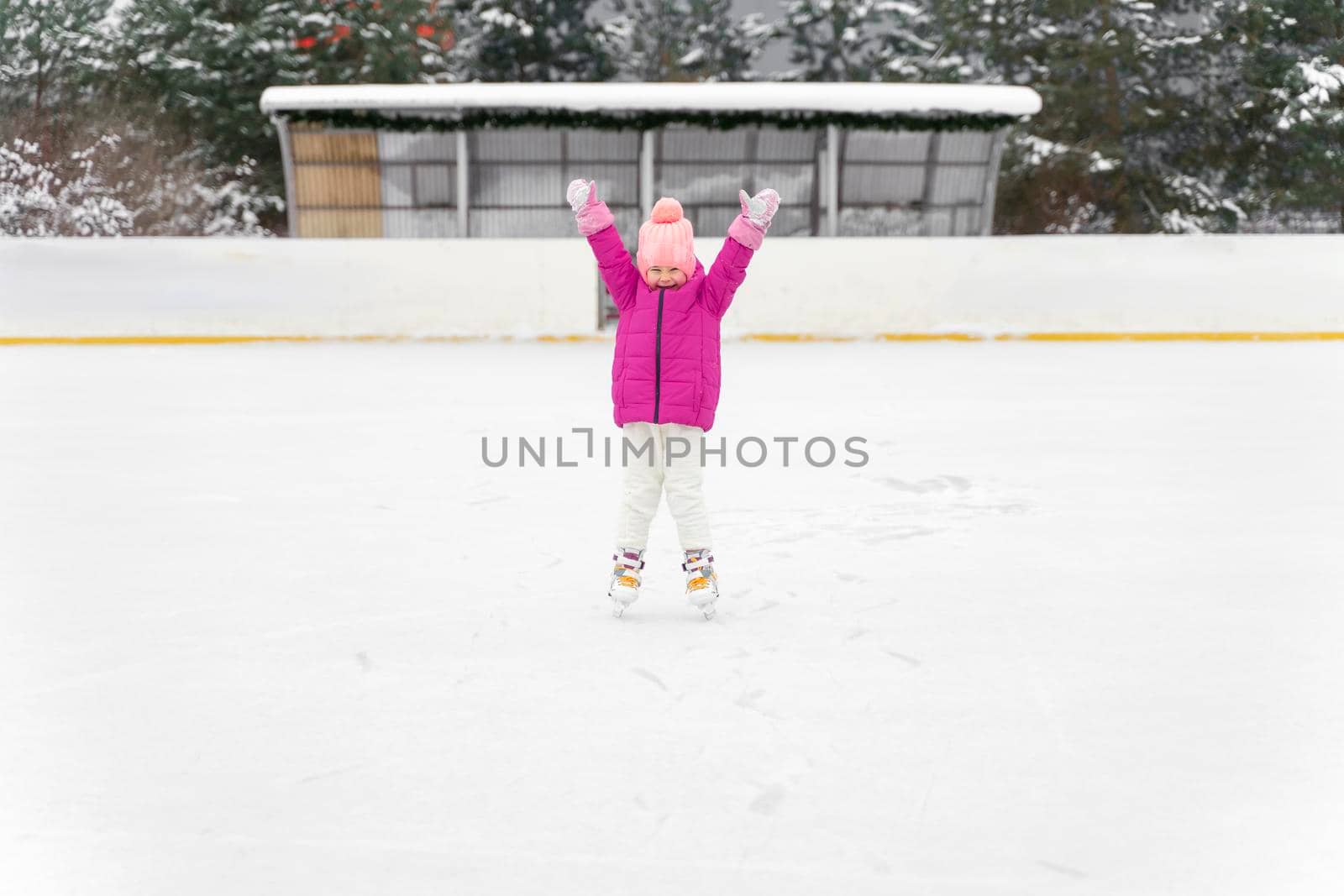 happy child at winter outdoor ice rink