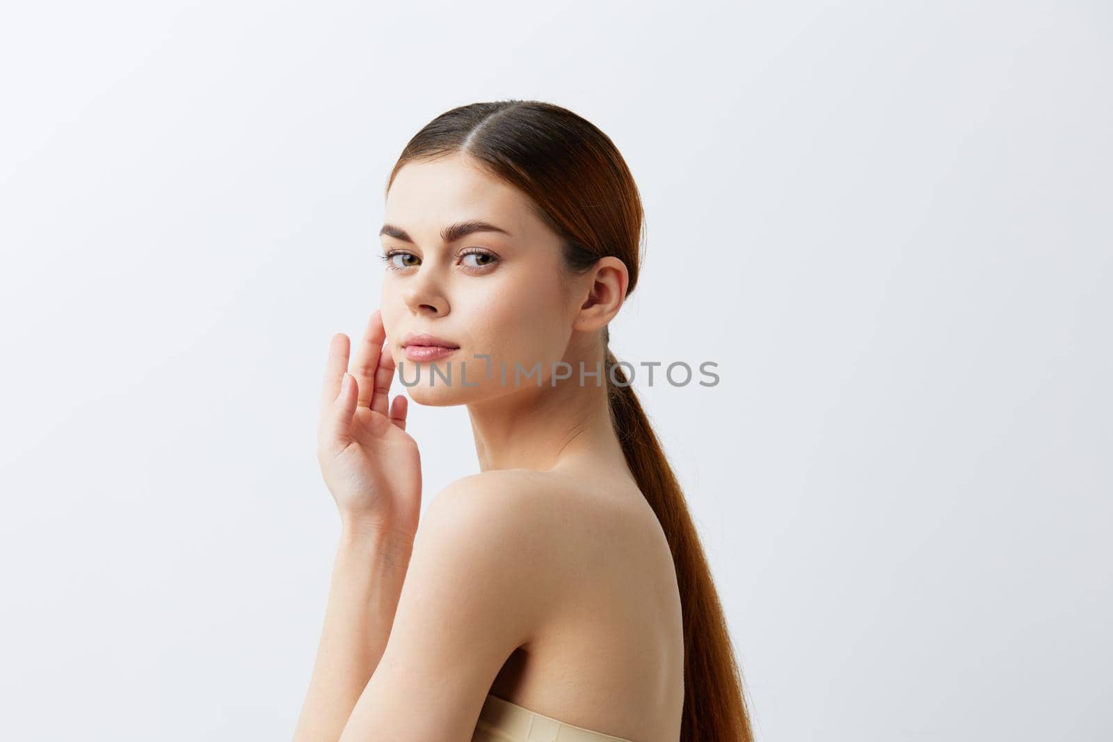 woman smiling woman bare shoulders clean skin charm Model light background. High quality photo
